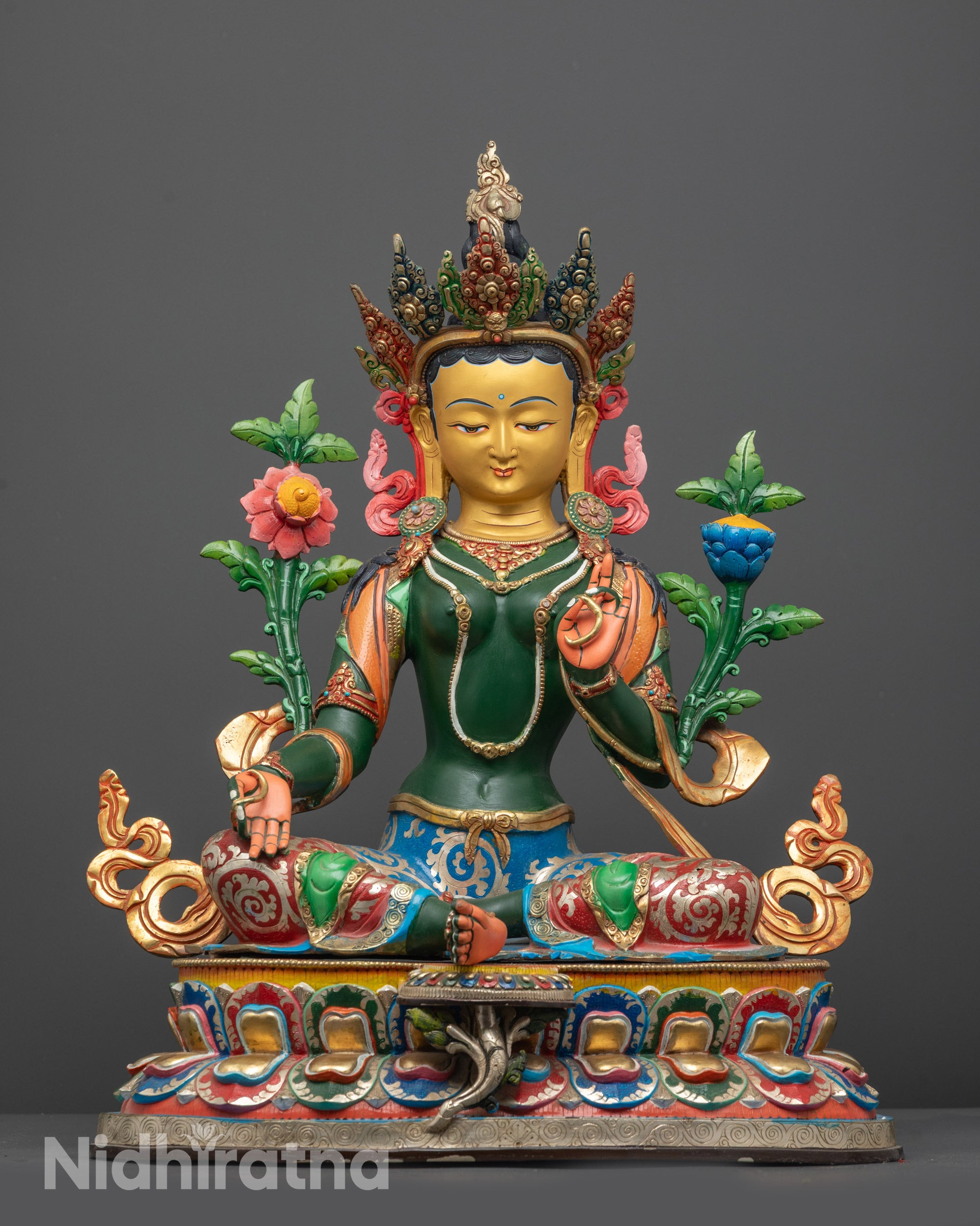 Front view of Green Tara statue with gold-gilded face and colored lotus seat