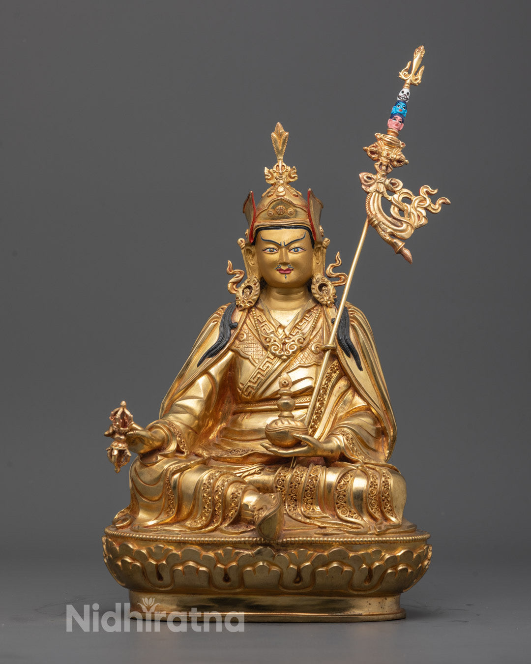 Front view of Guru Padmasambhava Statue with gold-gilded face and lotus throne.