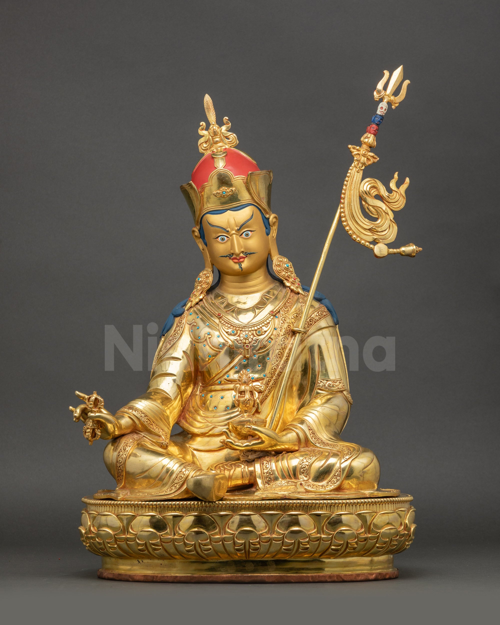 Front view of Guru Rinpoche Statue seated on lotus base with vajra and skull cup