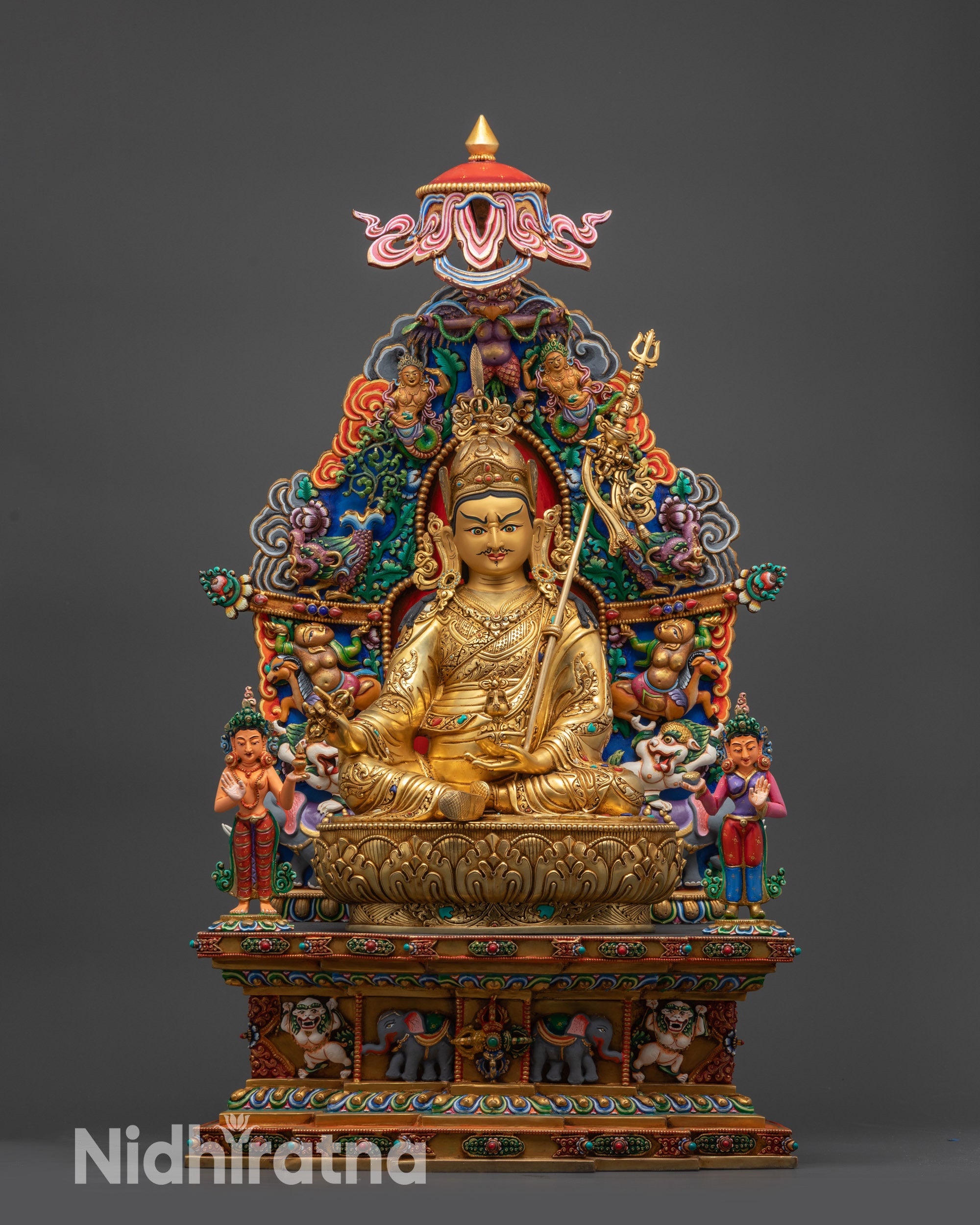 Front view of Guru Rinpoche statue seated on lotus throne with disciples