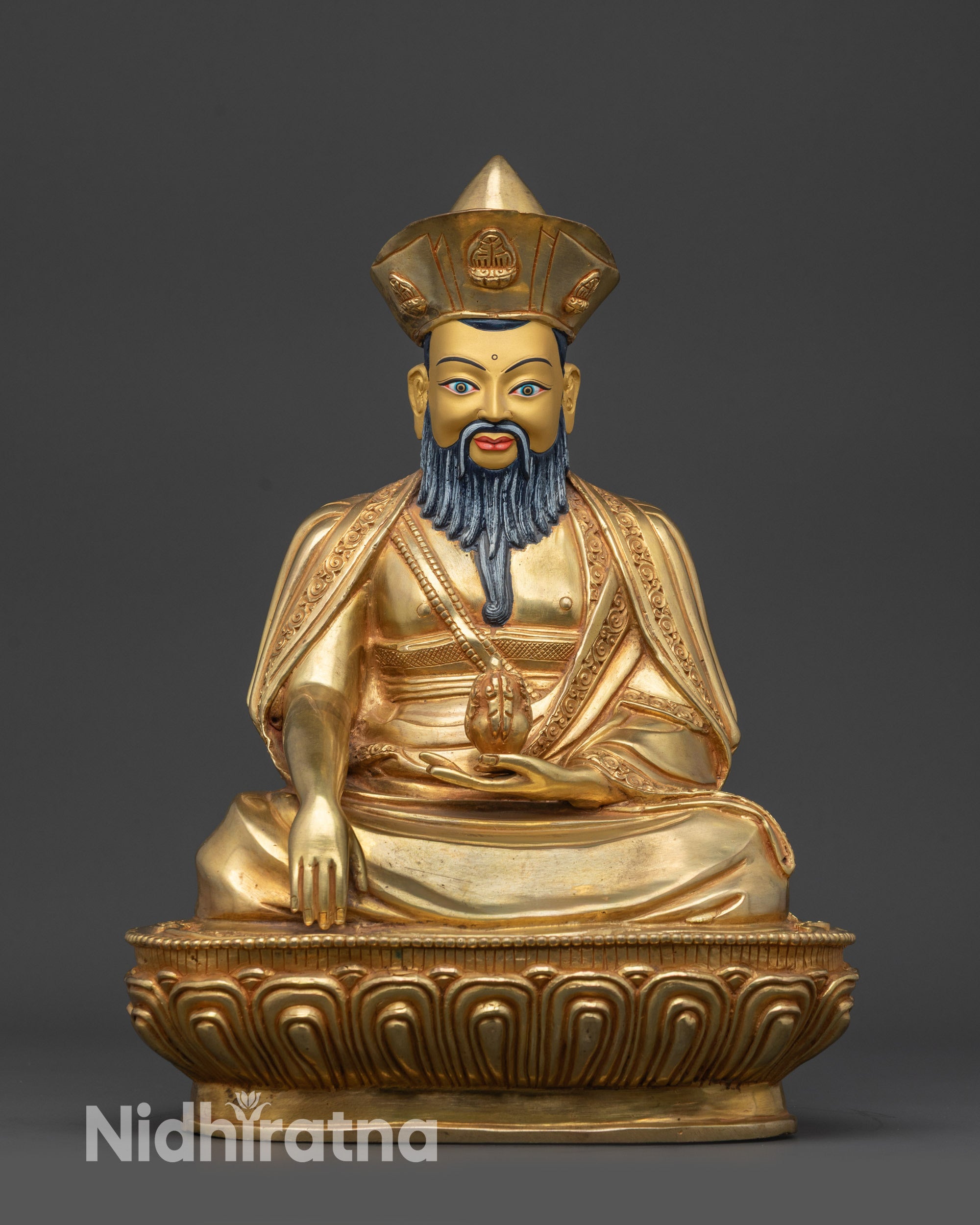 Front view of Guru Shapdum statue on lotus pedestal with gold-gilded face and robes