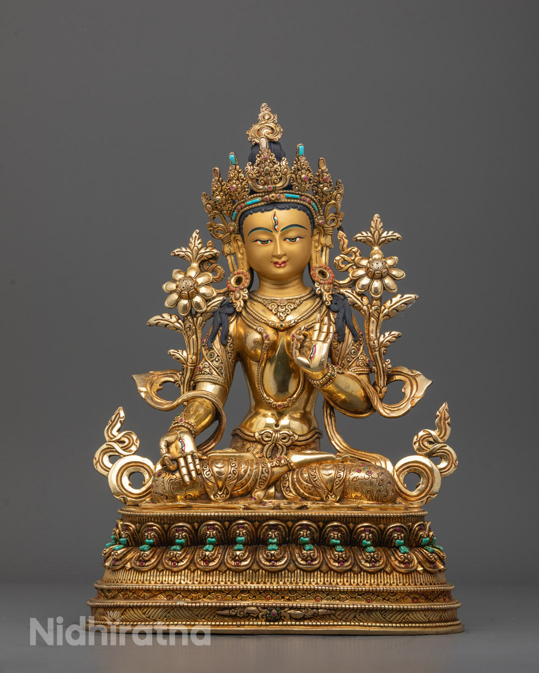 Front view of Handcrafted White Tara Sculpture with 24K gold gilded face and utpala flowers