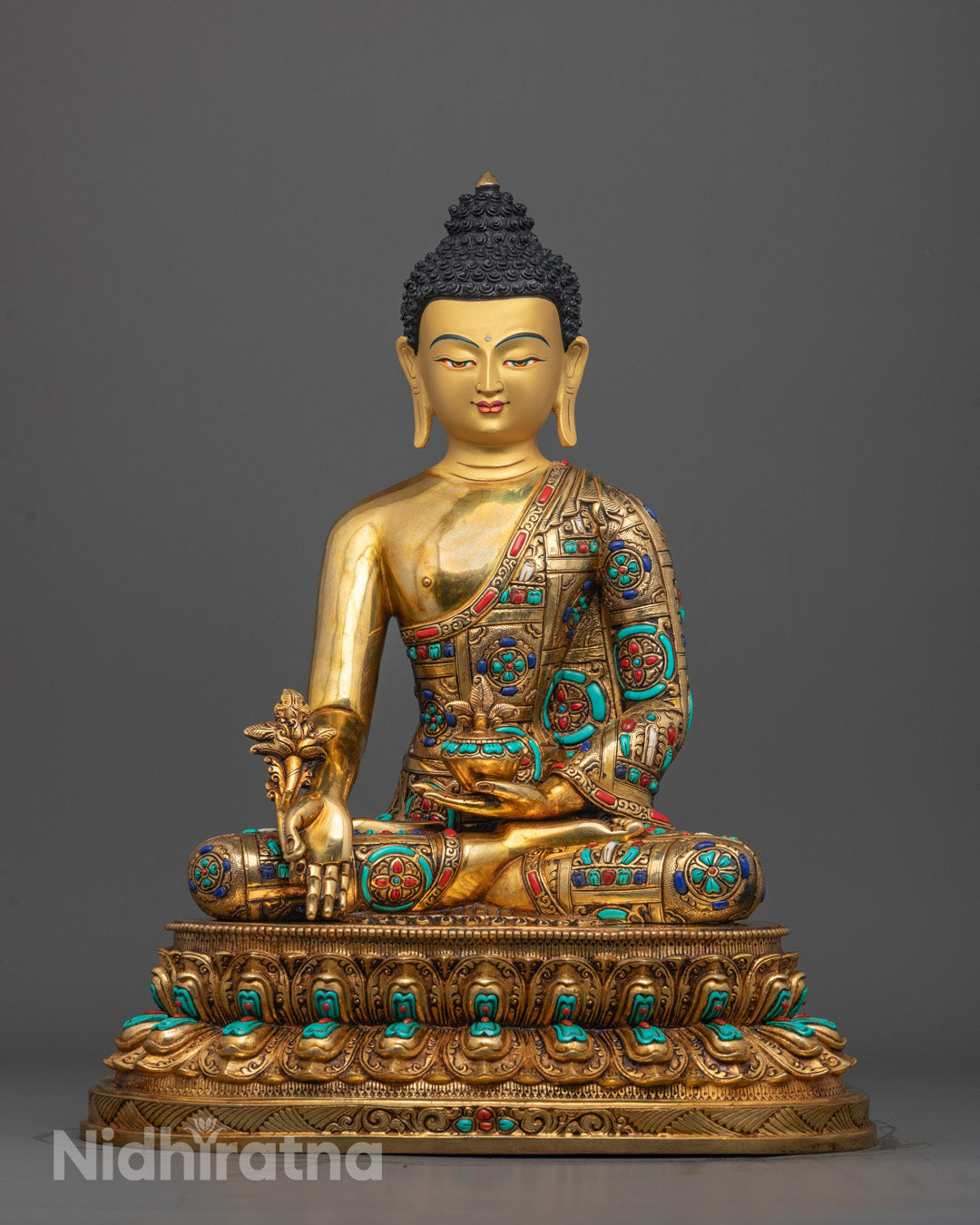 Front view of Medicine Buddha Bhaisajyaguru Statue with gold-gilded face and gemstones