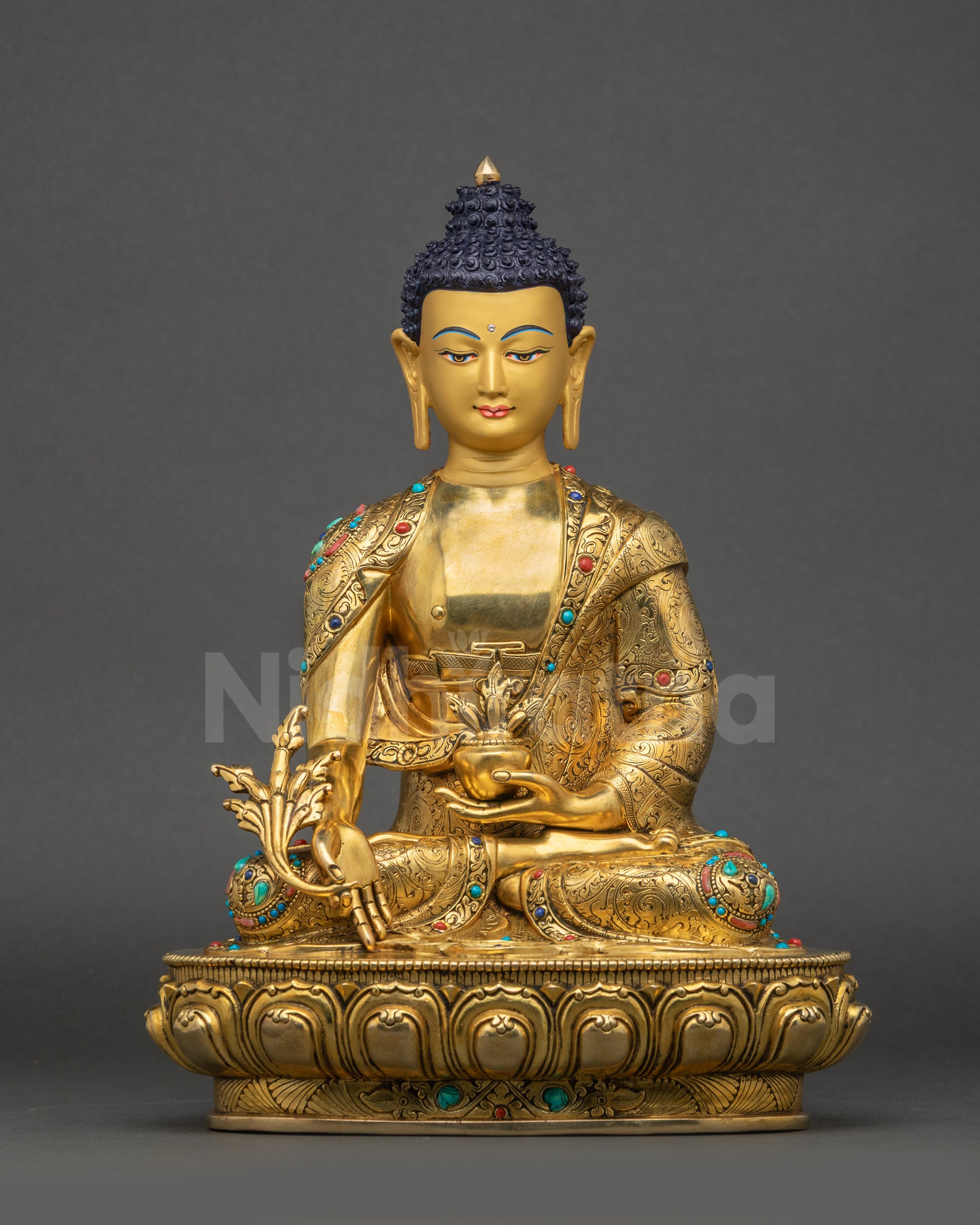 Front view of Medicine Buddha statue with gold-gilded face holding myrobalan stem and bowl