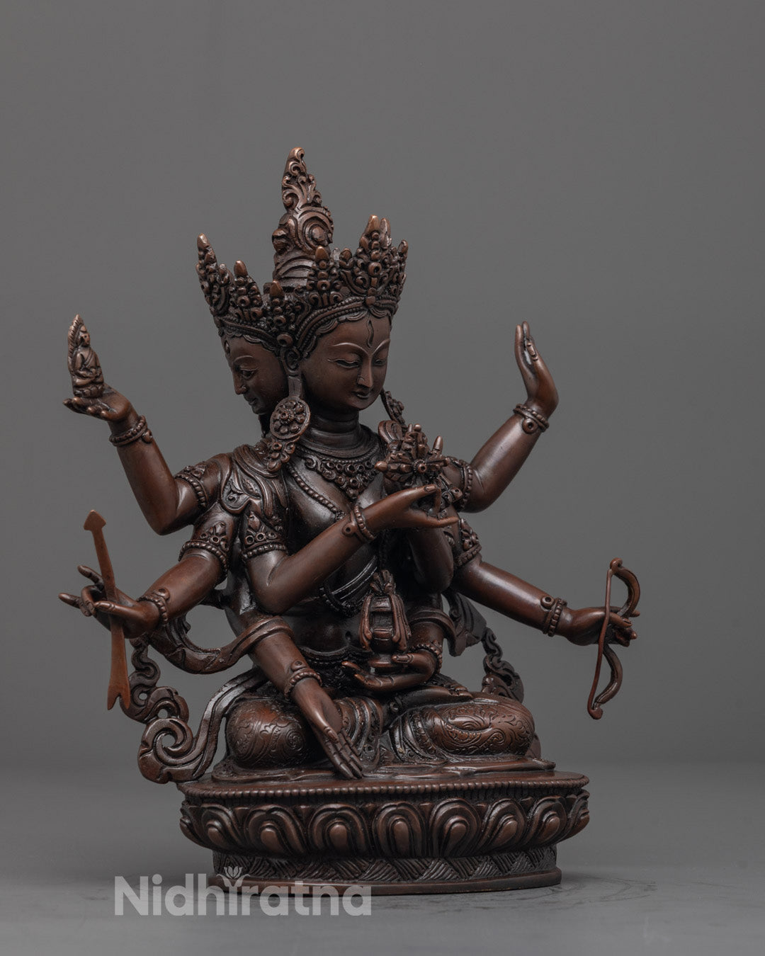 Front view of Namgyalma Sculpture, showcasing oxidized copper finish