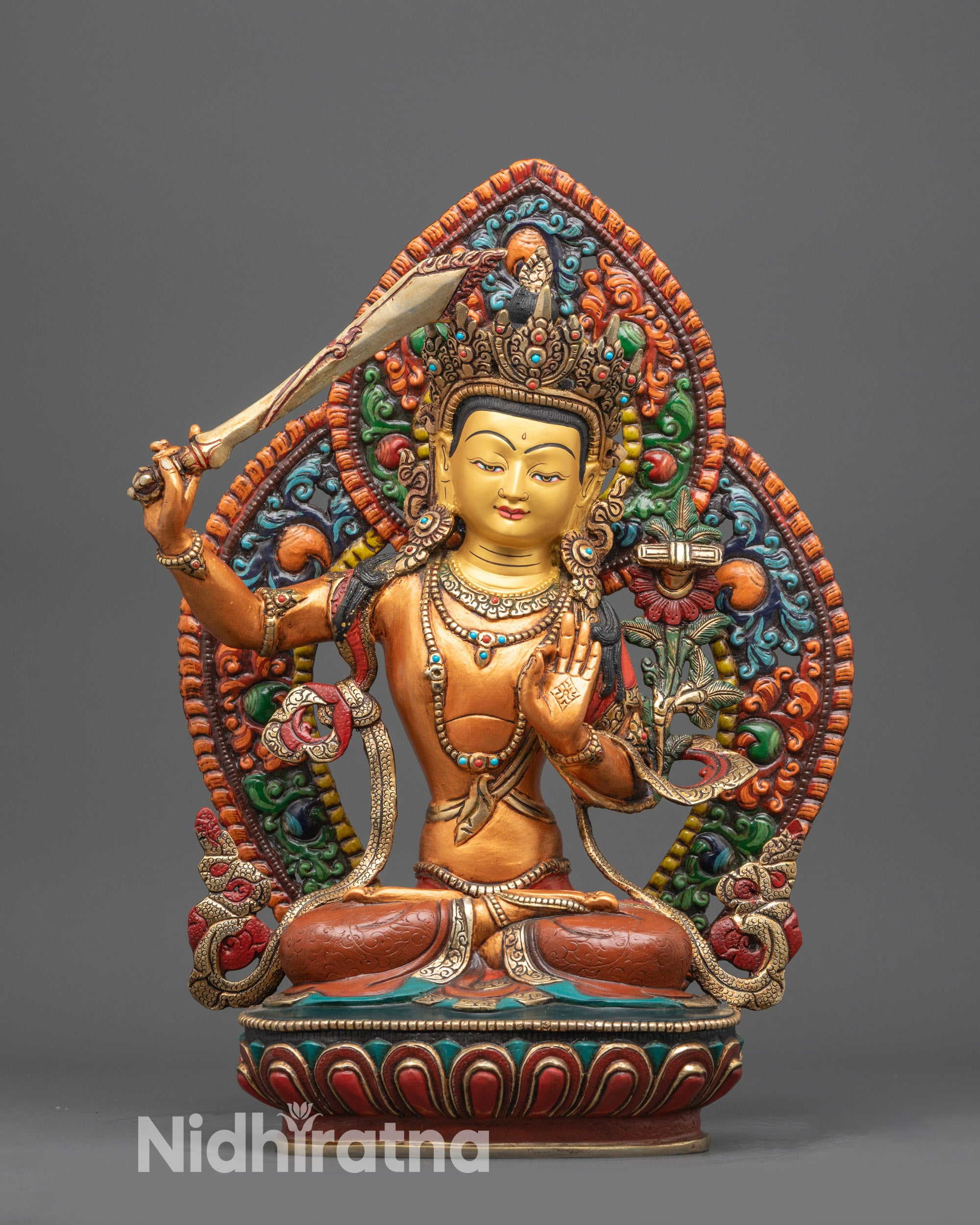 Front view of Nepalese Arapacana Manjushri statue with gold-gilded face and robes
