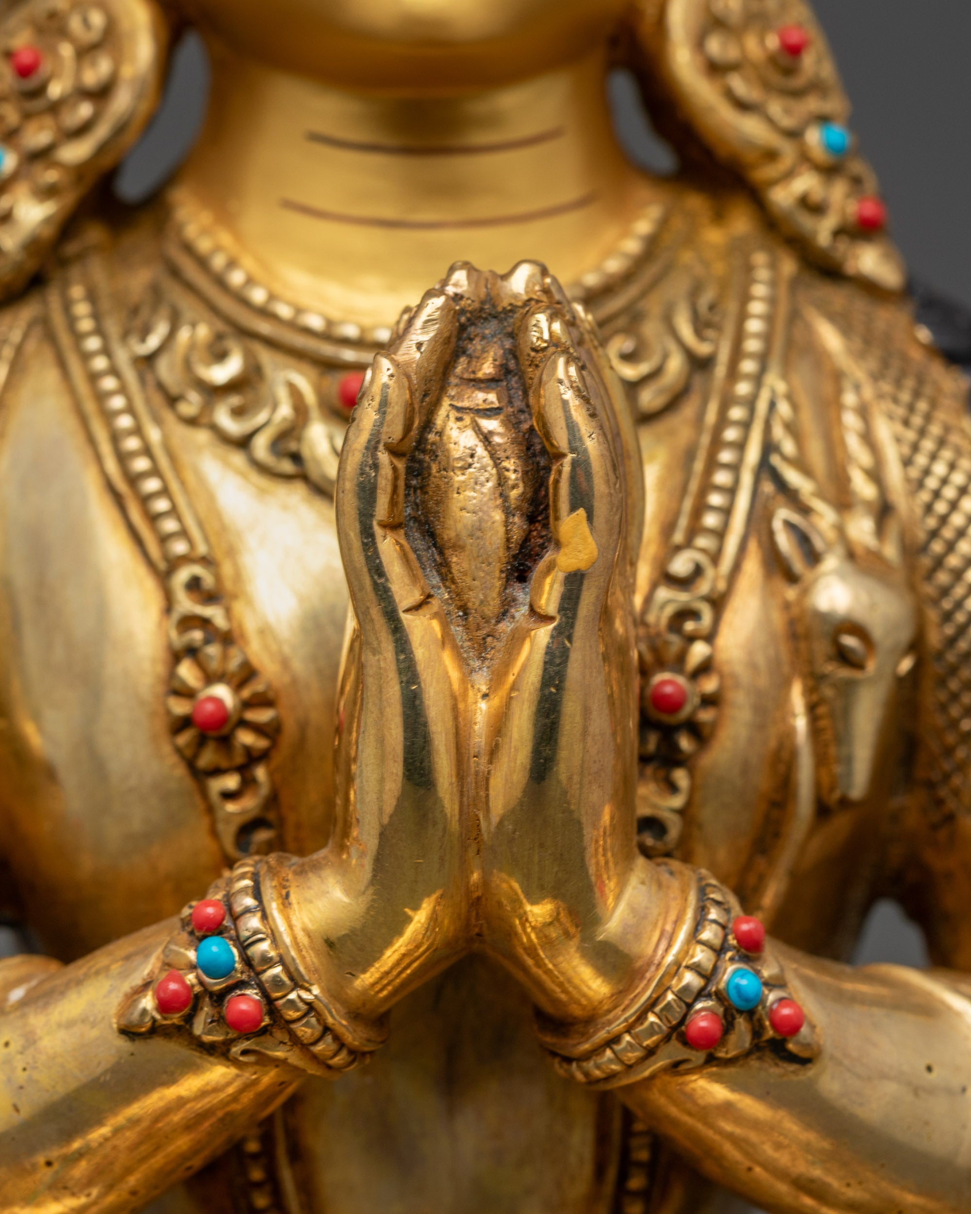 Front view of Nepalese Chenrezig statue adorned with coral, turquoise, and lapis lazuli