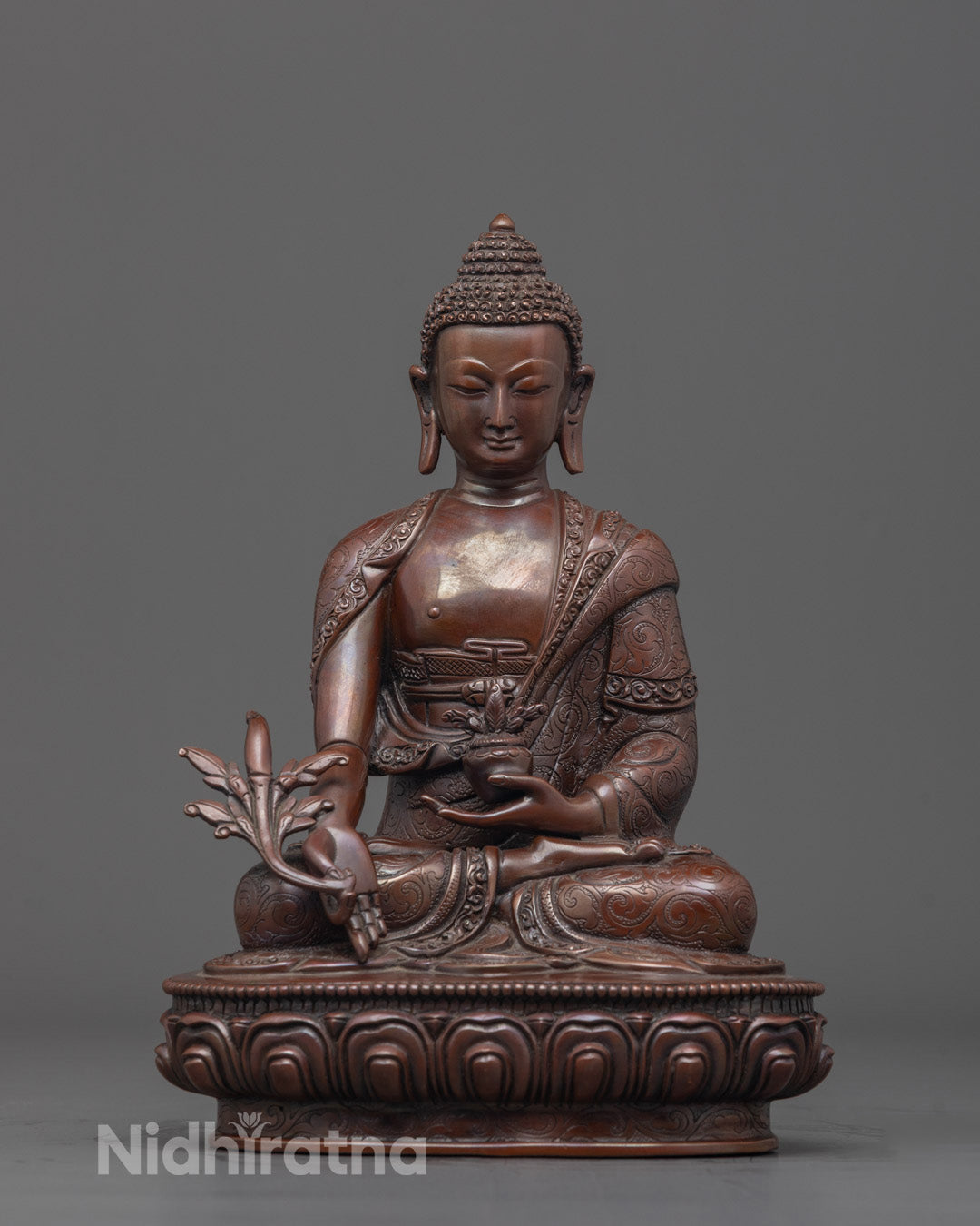 Front view of Oxidized Medicine Buddha Statue holding Utpala flower and medicinal bowl