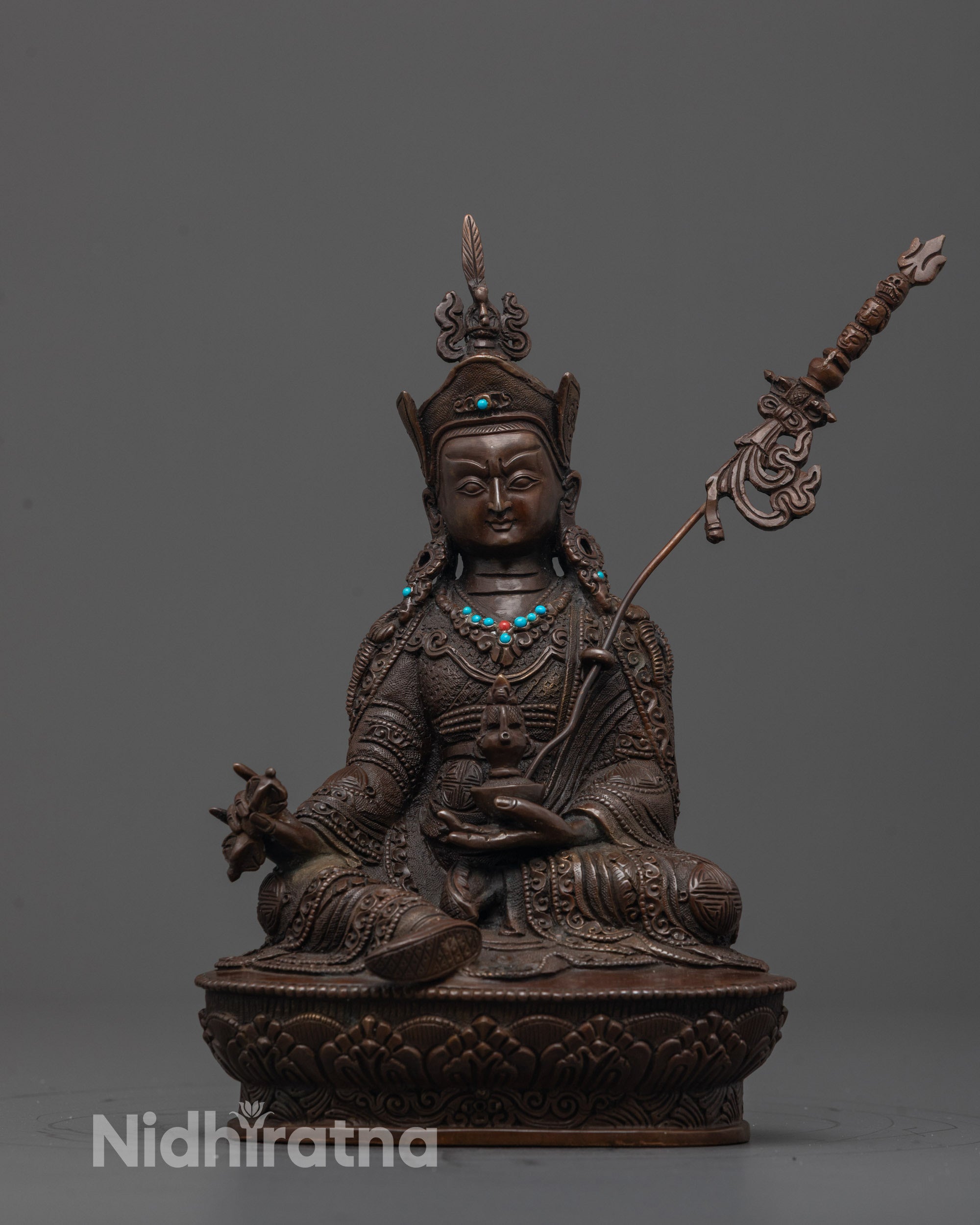Front view of Padmasambhava Statue with oxidized copper finish and detailed lotus crown and robes