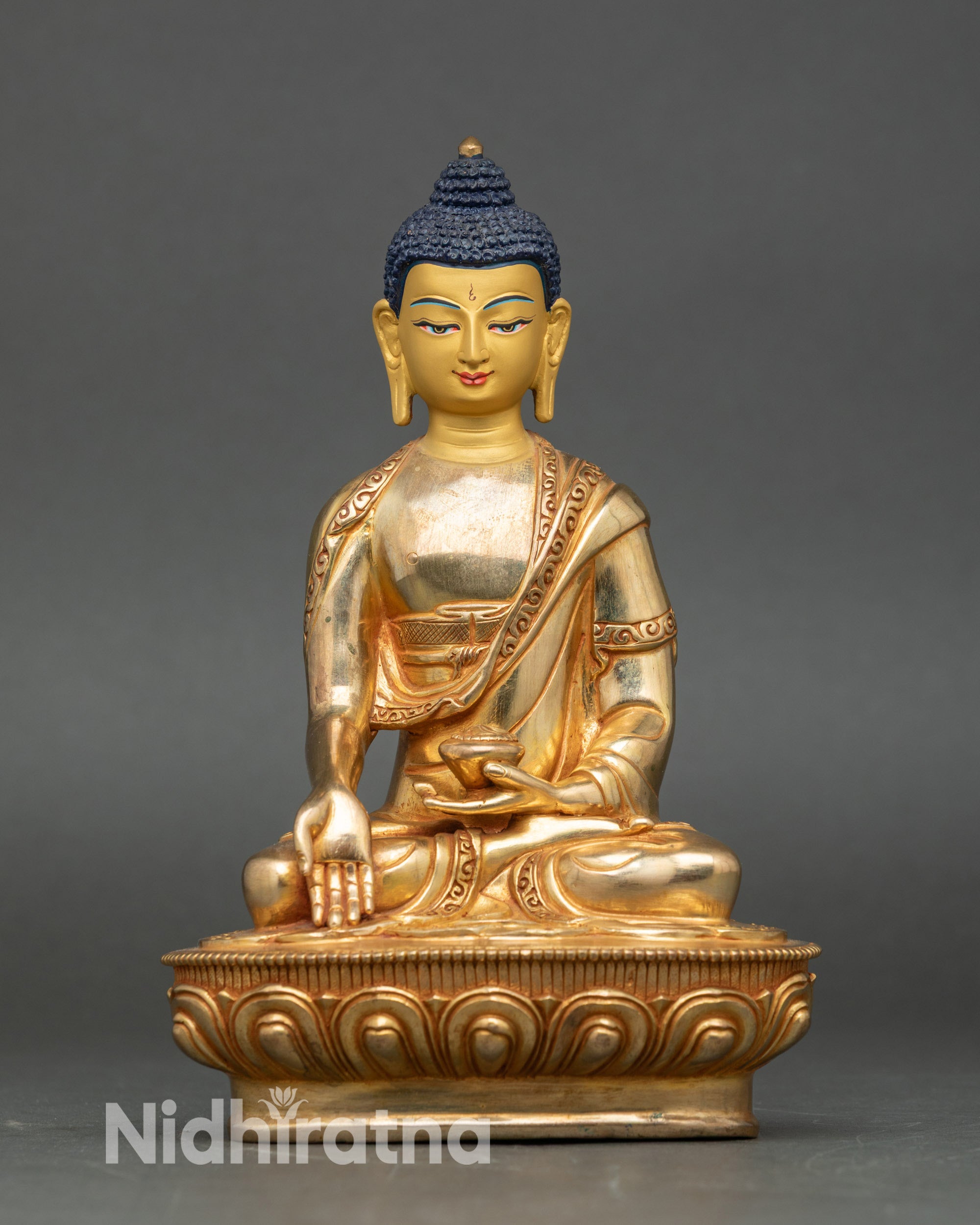 Front view of Ratnasambhava Buddha statue, handcrafted copper with 24K gold details
