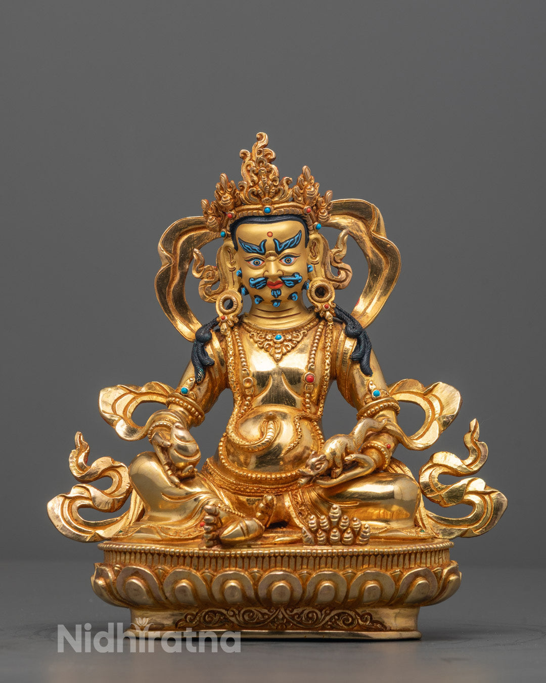 Front view of Traditional Dzambhala Sculpture with 24K gold face and gold fire body