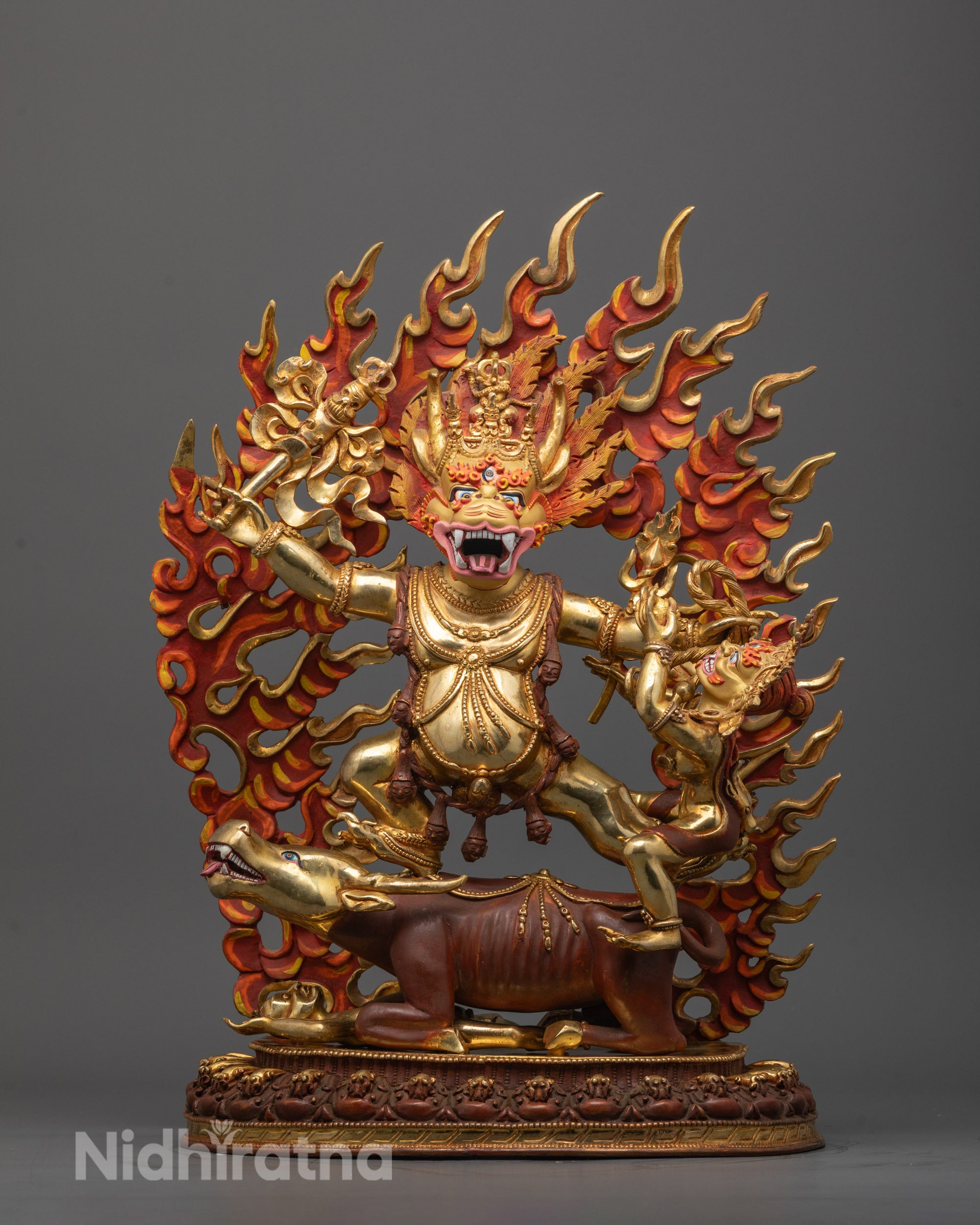 Front view of Vajrabhairava Yamantaka Consort Sculpture with 24K gold-gilded face standing on partially gold-gilded Mahisha buffalo