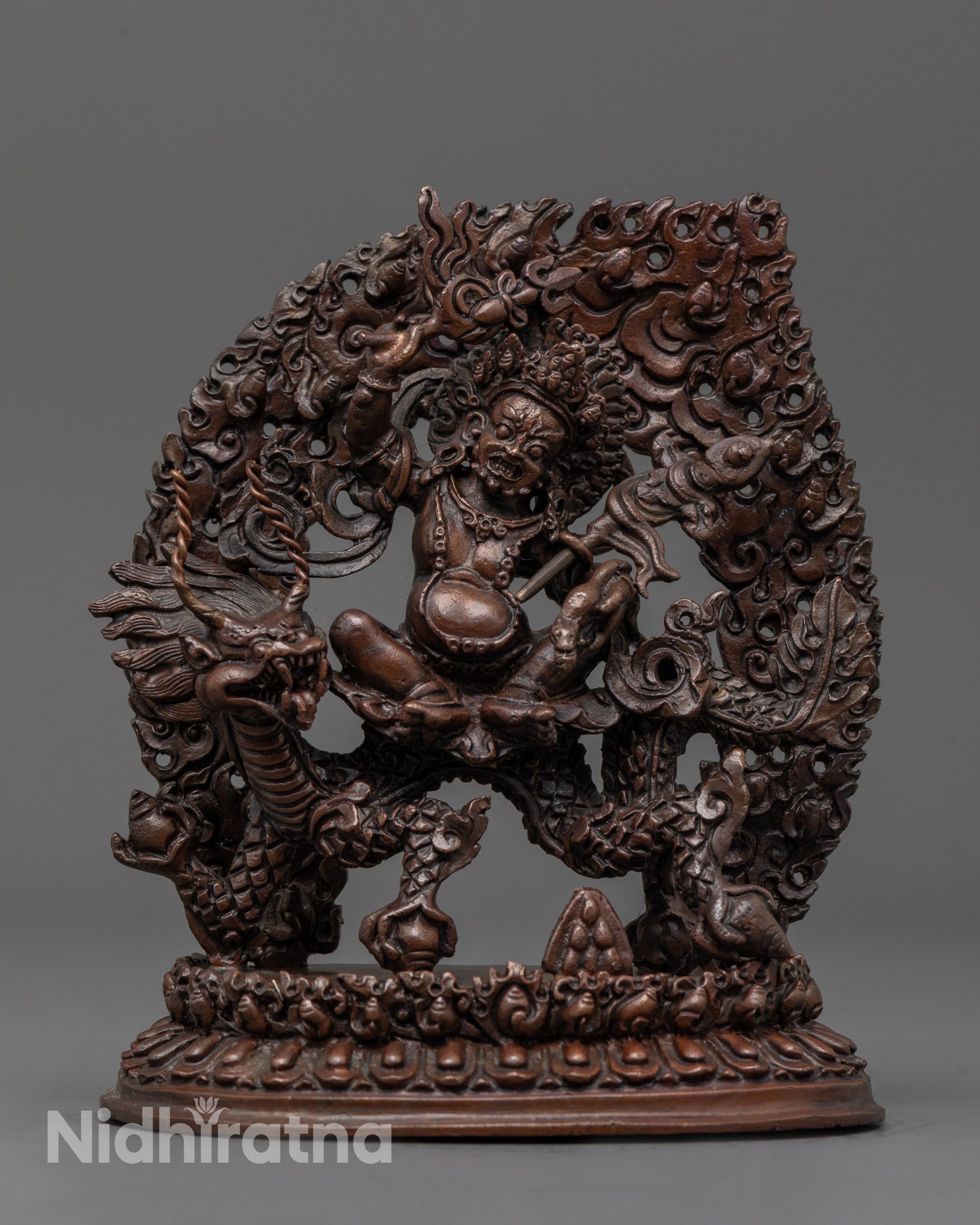Front view of White Dzambhala Statue riding dragon with sword and mongoose