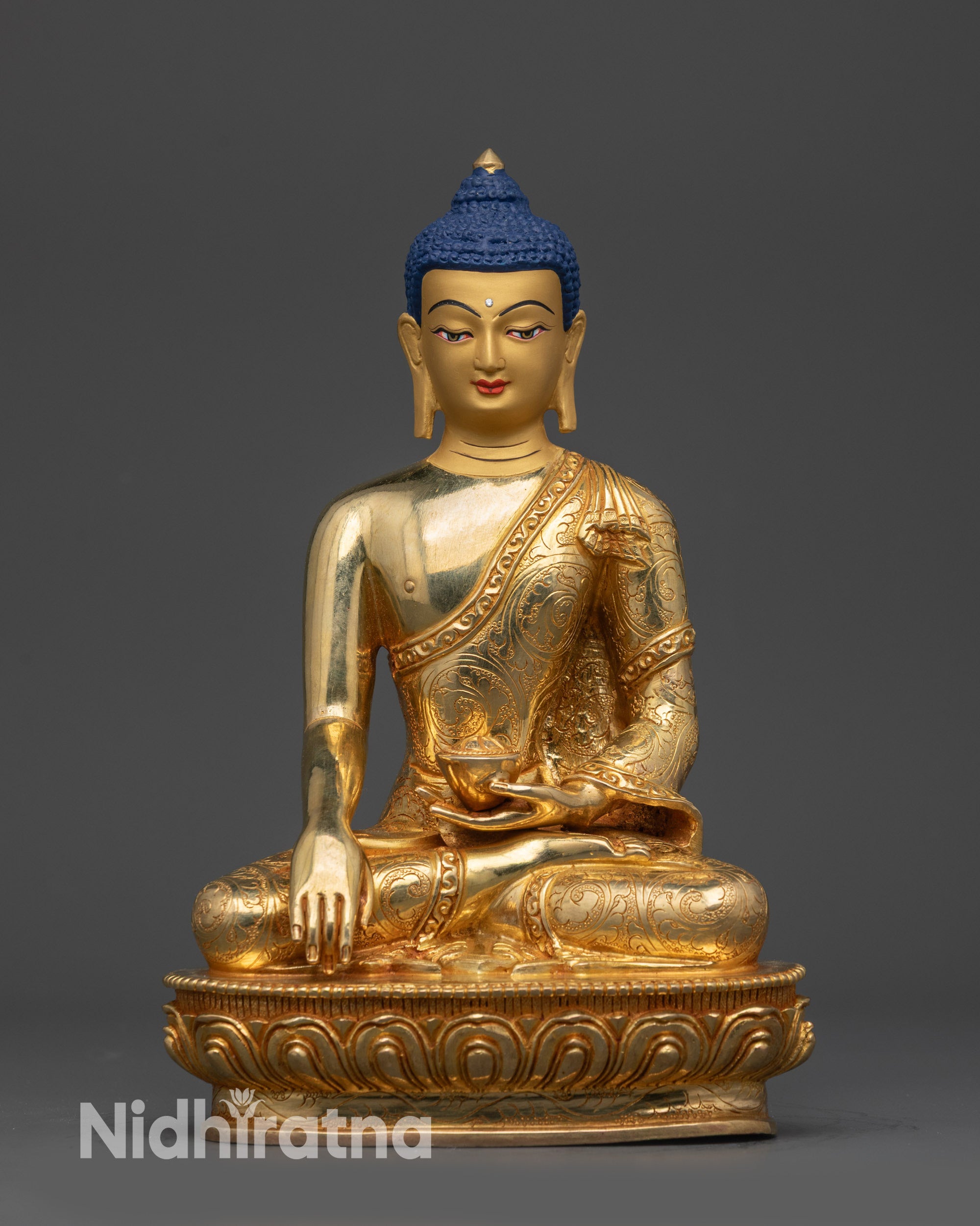 Front view of a gold-gilded Shakyamuni Buddha statue in earth-touching mudra.