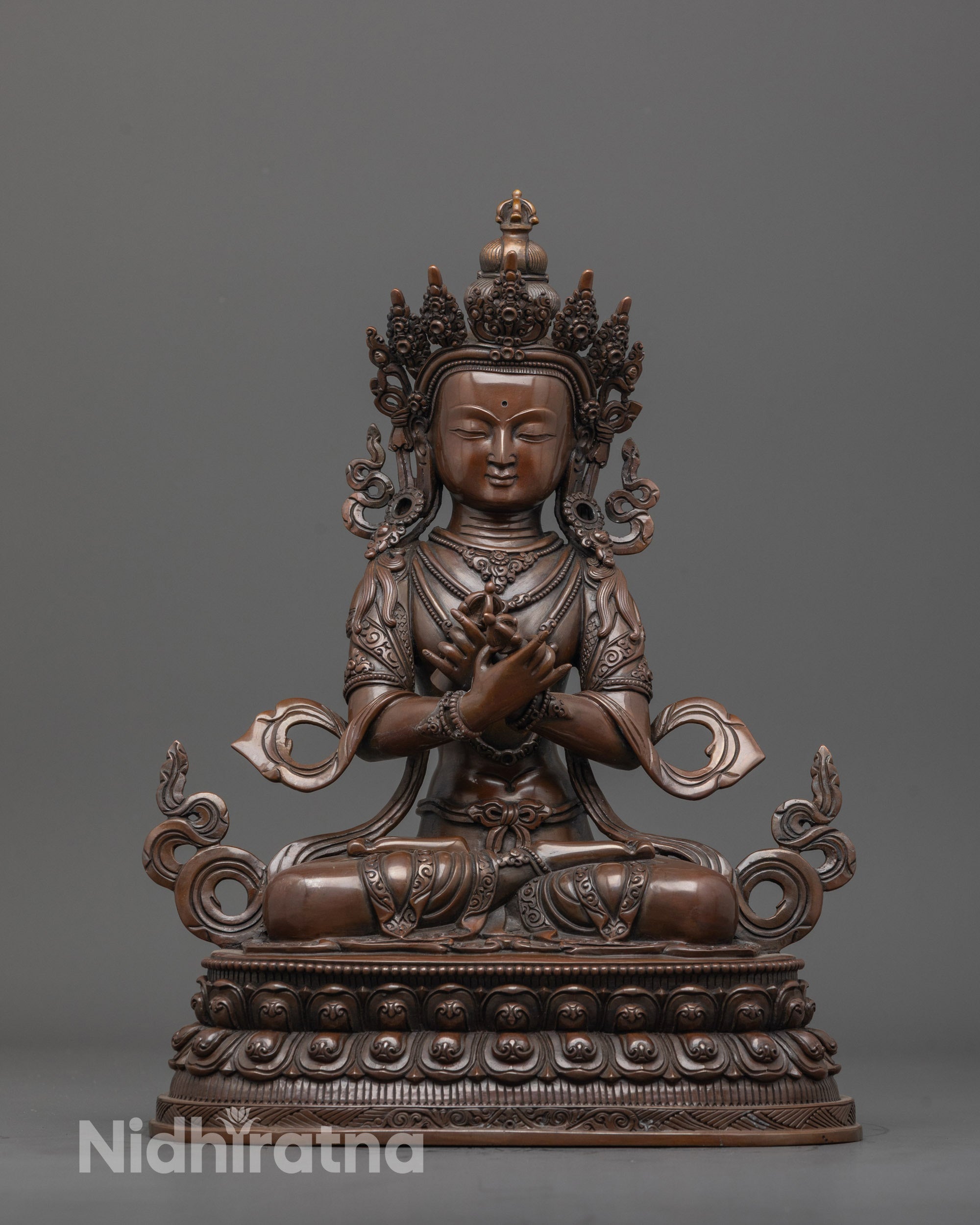 Front view of authentic oxidized Vajradhara statue with intricate carvings and double lotus base