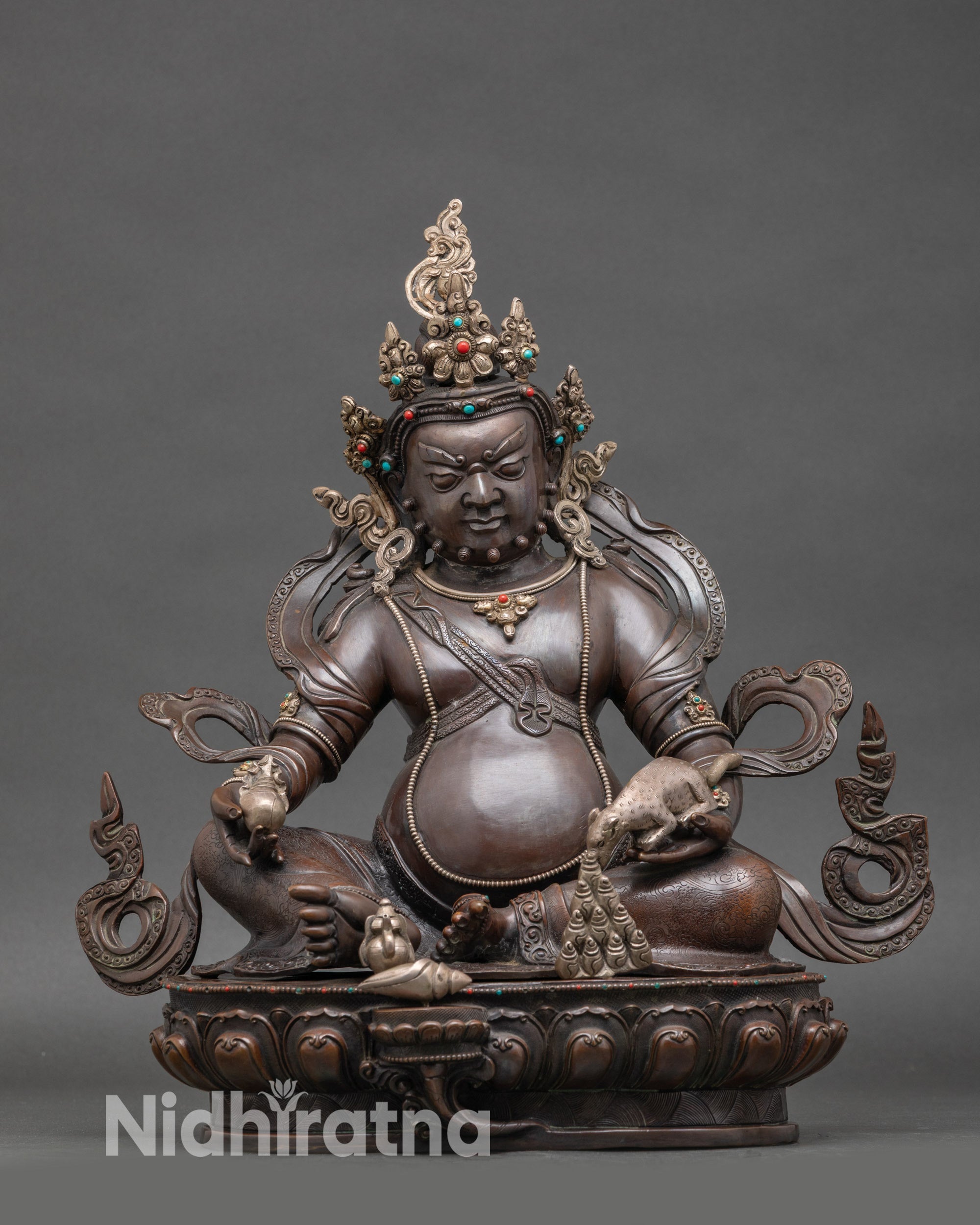 Front view of chemically oxidized Dzambhala sculpture for wealth, silver-plated Nepalese Buddhist idol