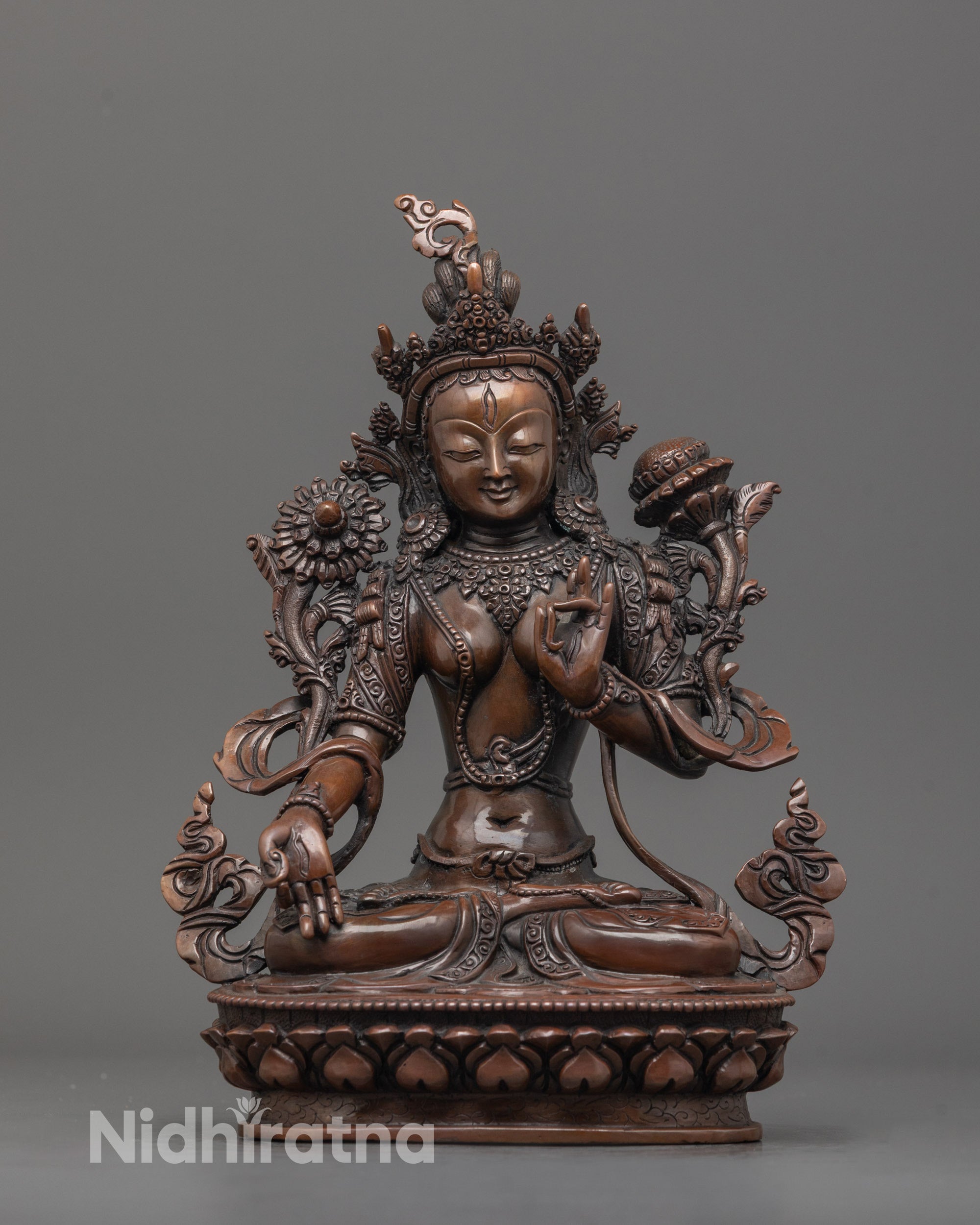 Front view of genuine oxidized White Tara statue with jeweled crown and utpala flowers