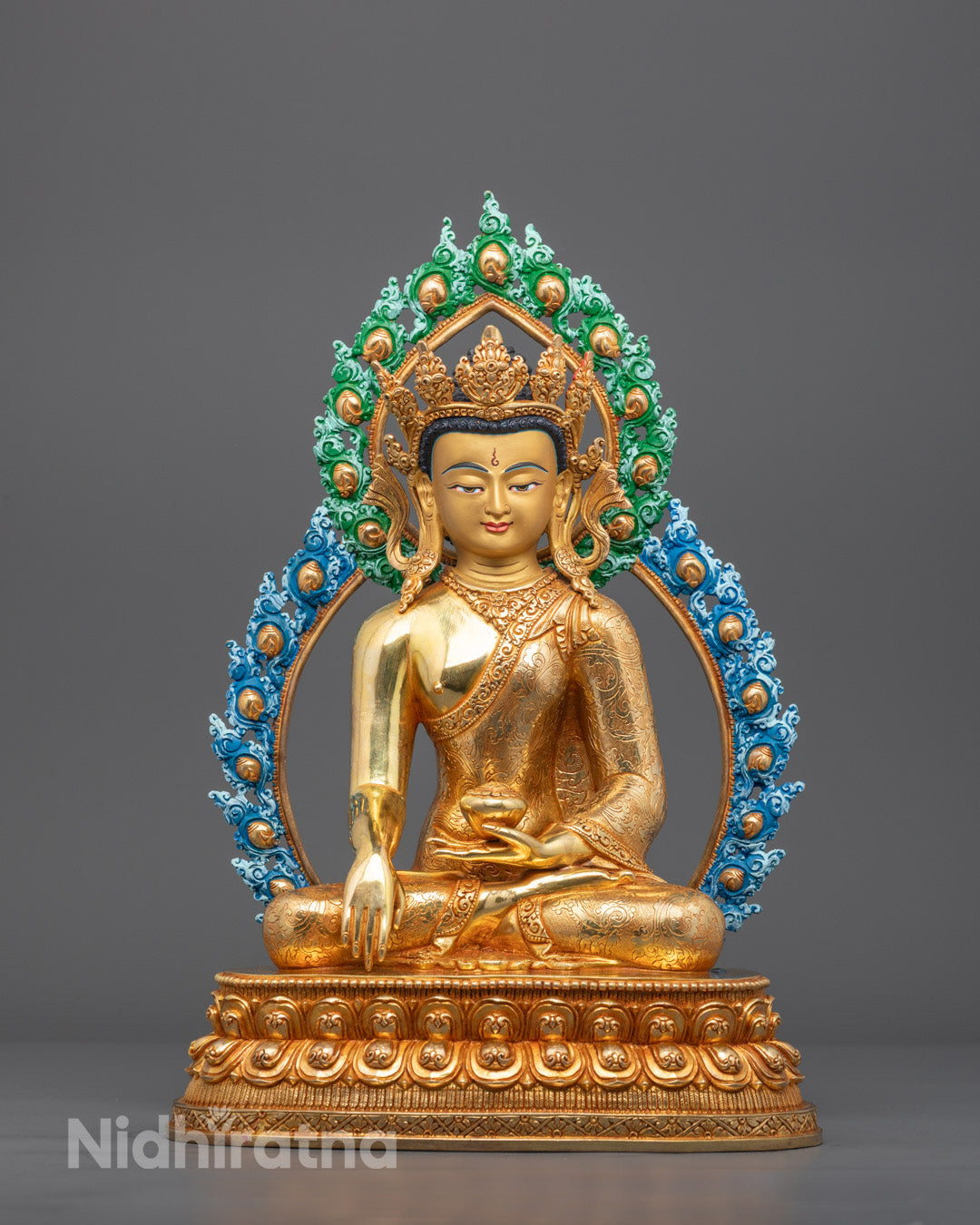 Front view of gold-gilded Bhagavan Buddha sculpture in Bhumisparsha Mudra on lotus throne