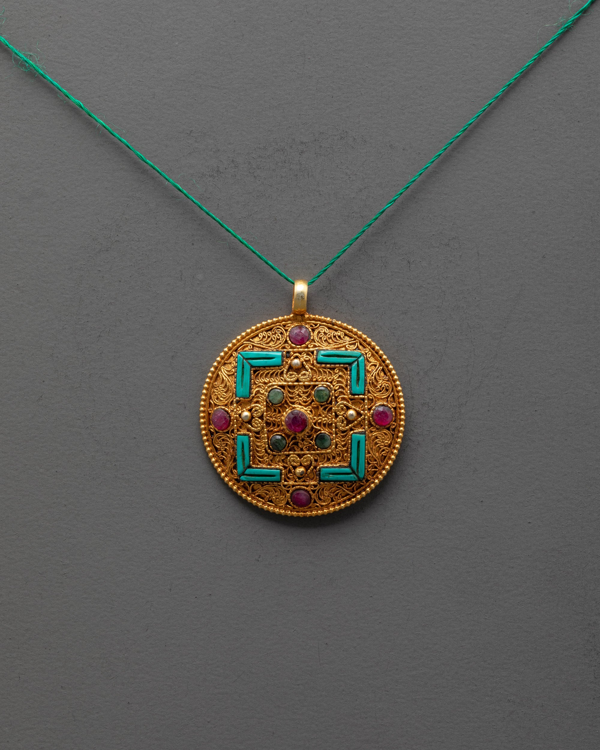 Front view of gold-plated Mandala Locket with filigree design and semi-precious stones