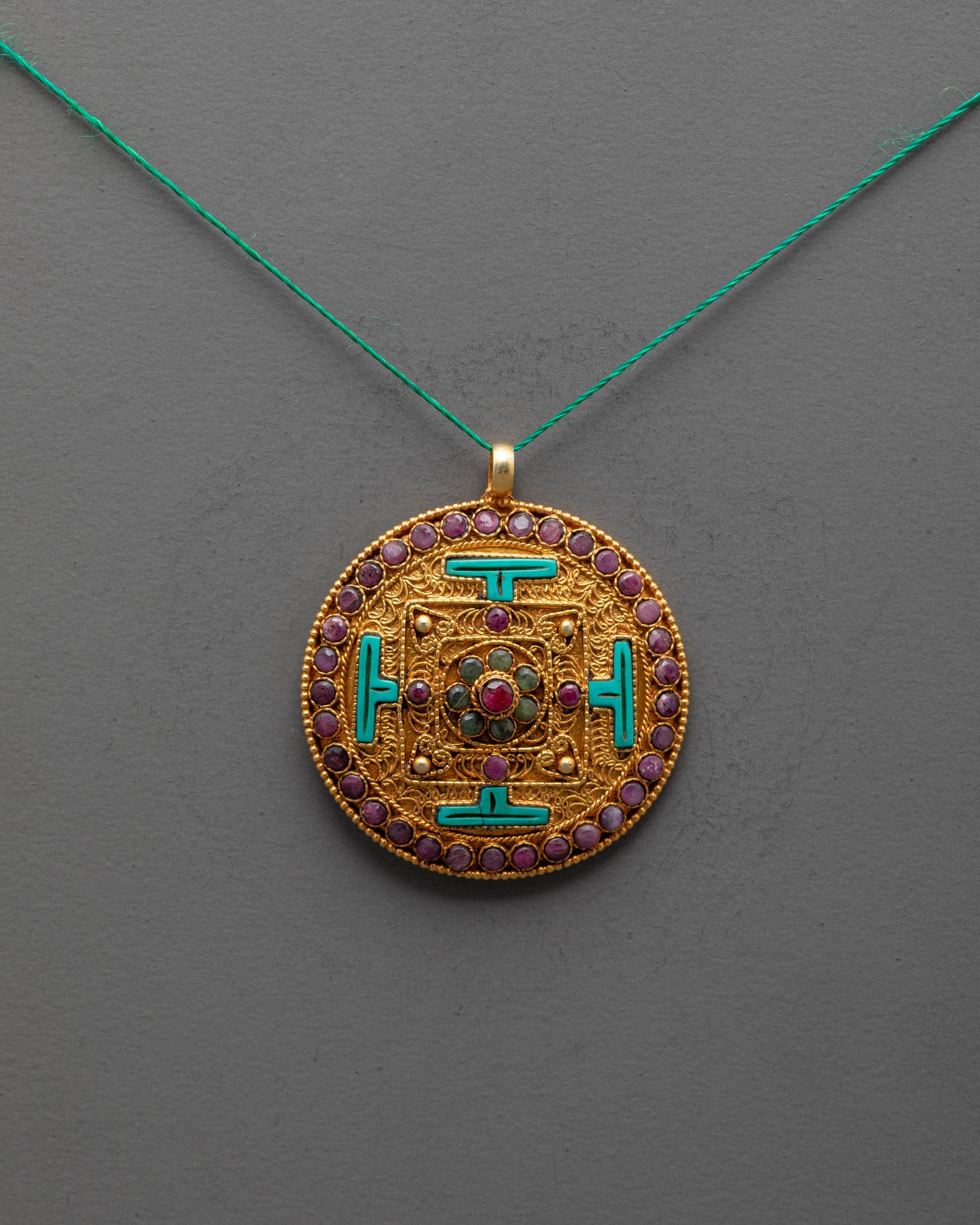 Front view of gold-plated Mandala Locket with intricate filigree and semi-precious gems