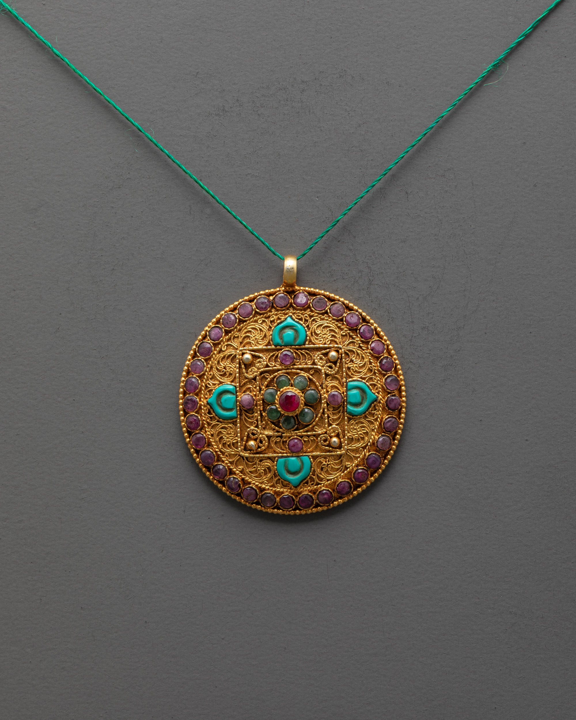 Front view of gold-plated Mandala Locket with turquoise petals and semi-precious gems
