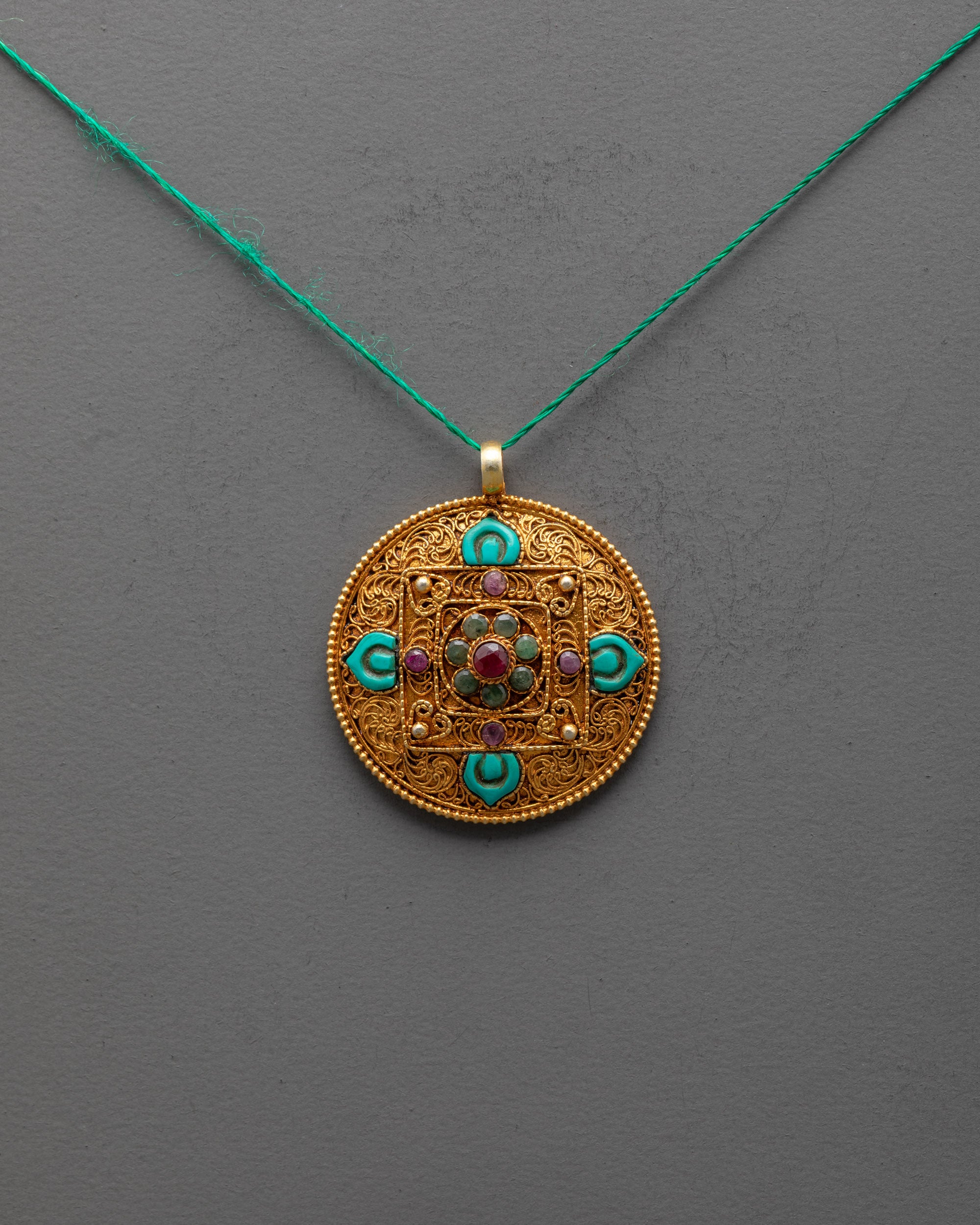 Front view of gold-plated Mandala Pendant with turquoise flower and semi-precious stones