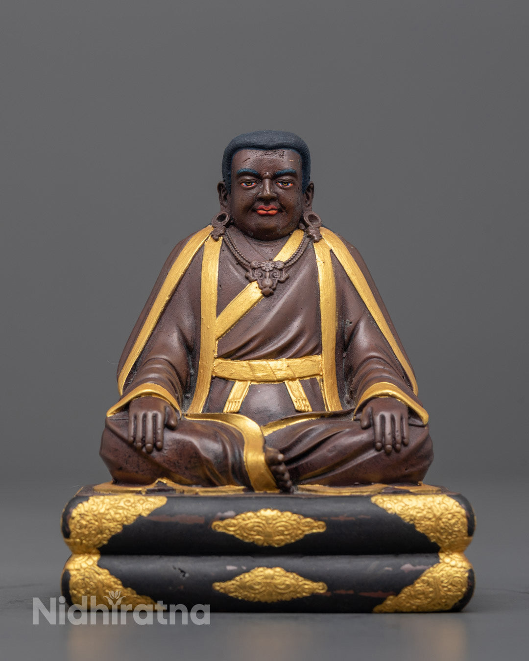 Front view of gold-plated Marpha statue with oxidized face and intricate carvings