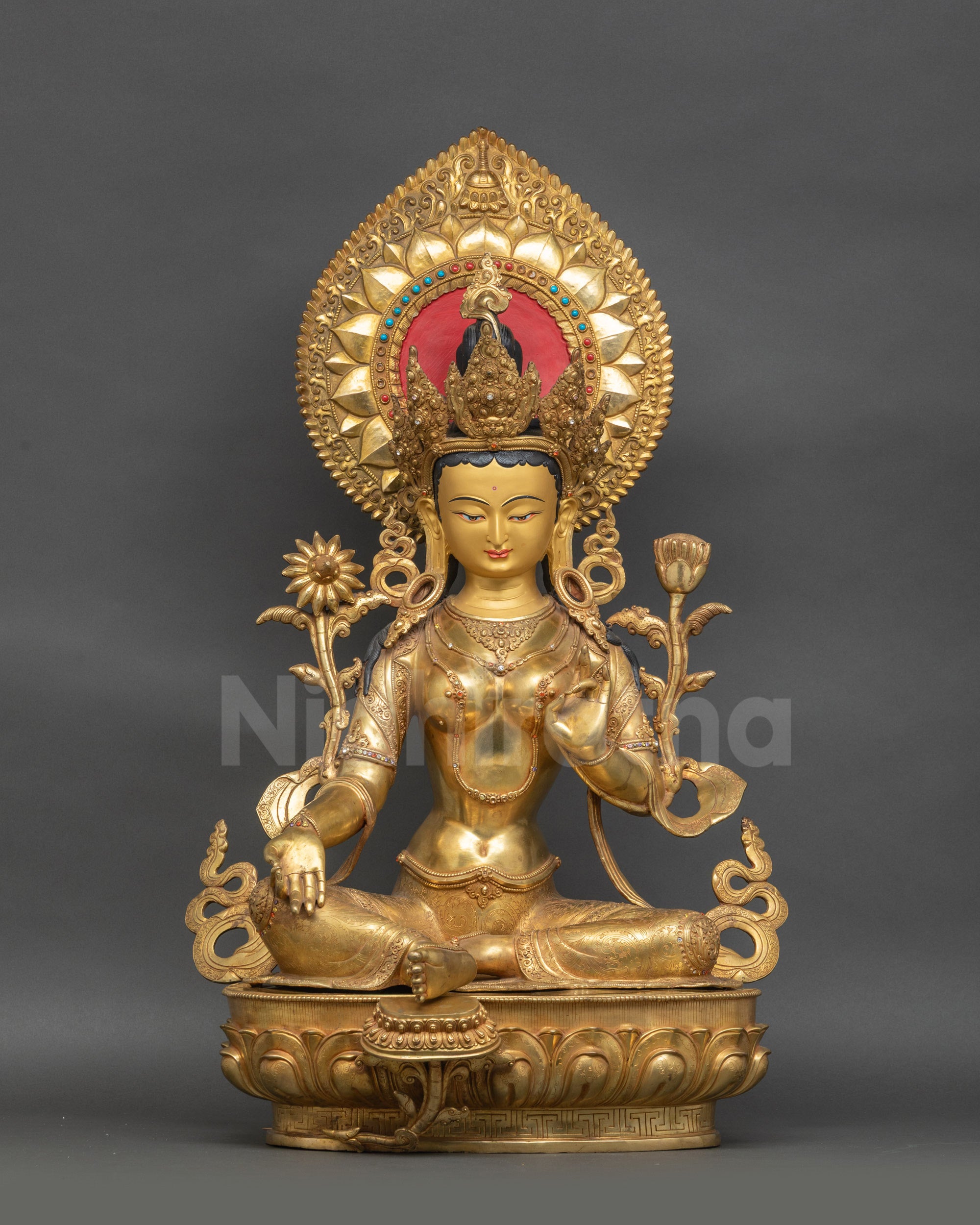Front view of gold fire-gilded Green Tara statue with Varada and Vitarka mudras