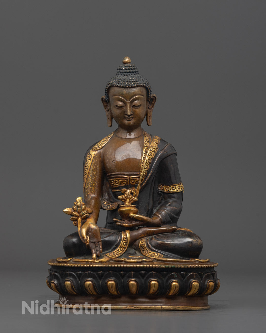 Front view of hand-carved Bhaisajyaguru Statue in oxidized copper with gold-plated details