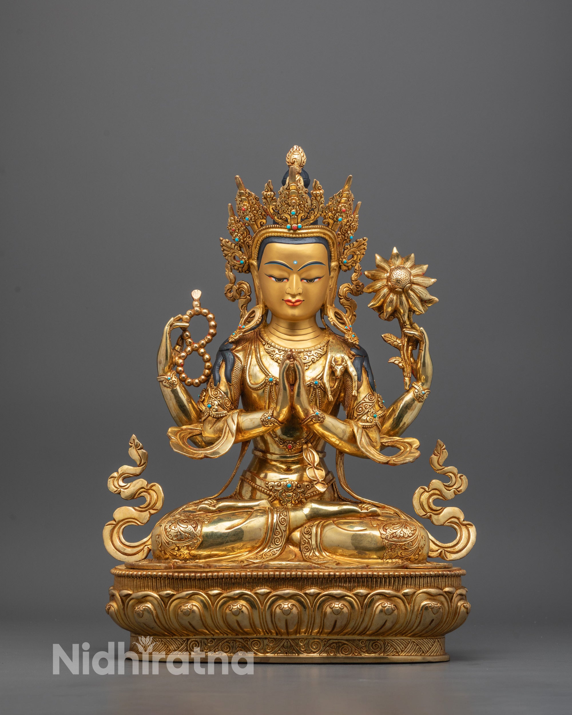 Front view of hand-carved Chenrezig Statue seated on a lotus throne with calm expression