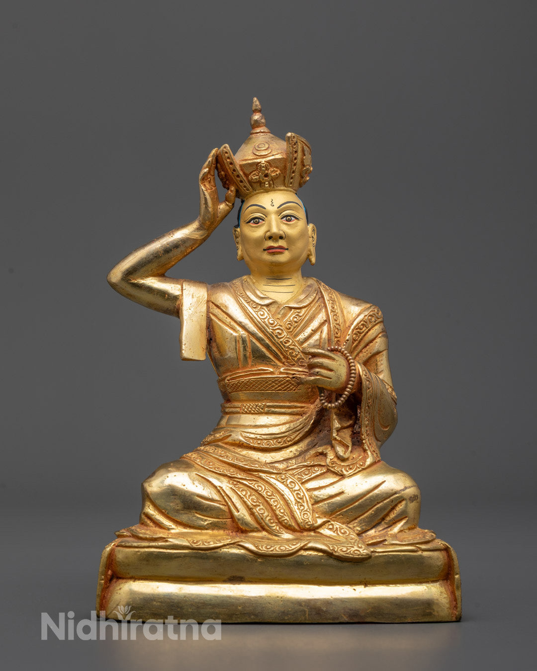 Front view of hand-carved Karmapa Statue in sleeping posture with 24k gold gilded face