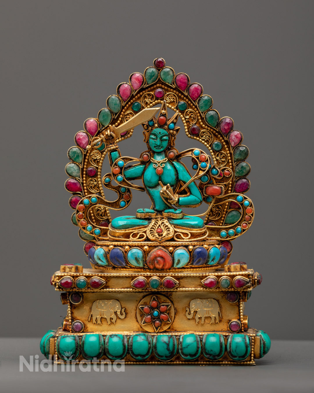 hand-carved Manjushri statue seated on a lotus throne, holding the sword of wisdom and a scripture.