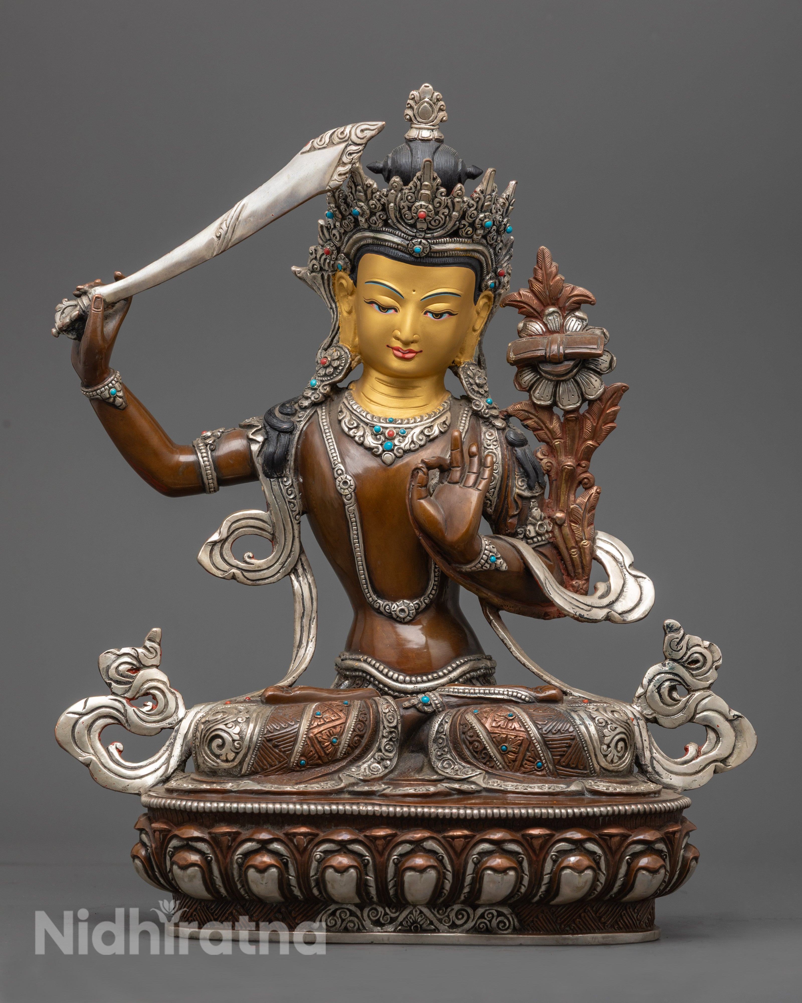 hand-carved Manjushri statue seated on lotus throne with flaming sword and wisdom book