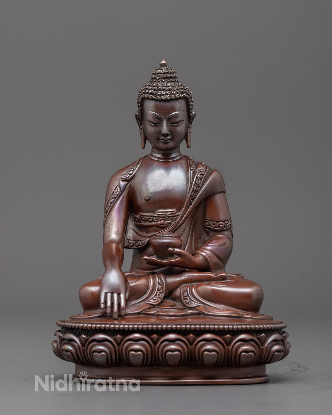 Front view of hand-carved Siddhartha Gautama Buddha Statue seated on lotus throne