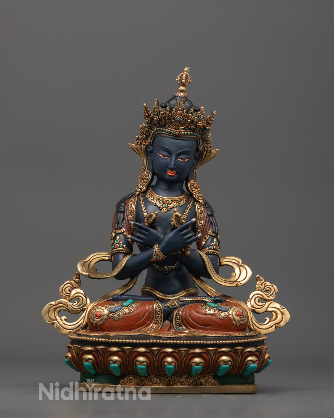 Front view of hand-carved Vajradhara statue with vajra