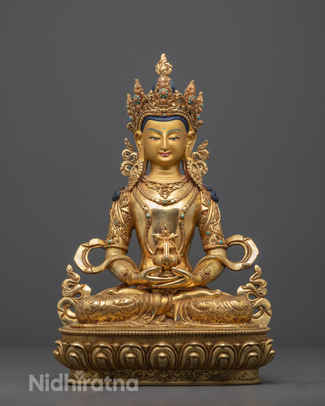 Front view of handcrafted Amitayus statue with 24k gold gilding and semi-precious stones on a copper base