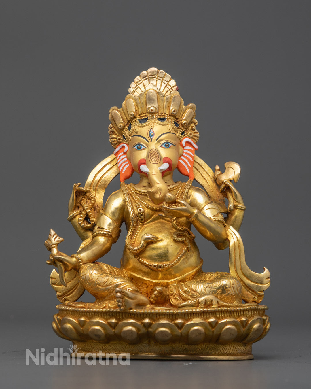 Front view of handcrafted Ganesha statue with gold-gilded face and detailed carvings