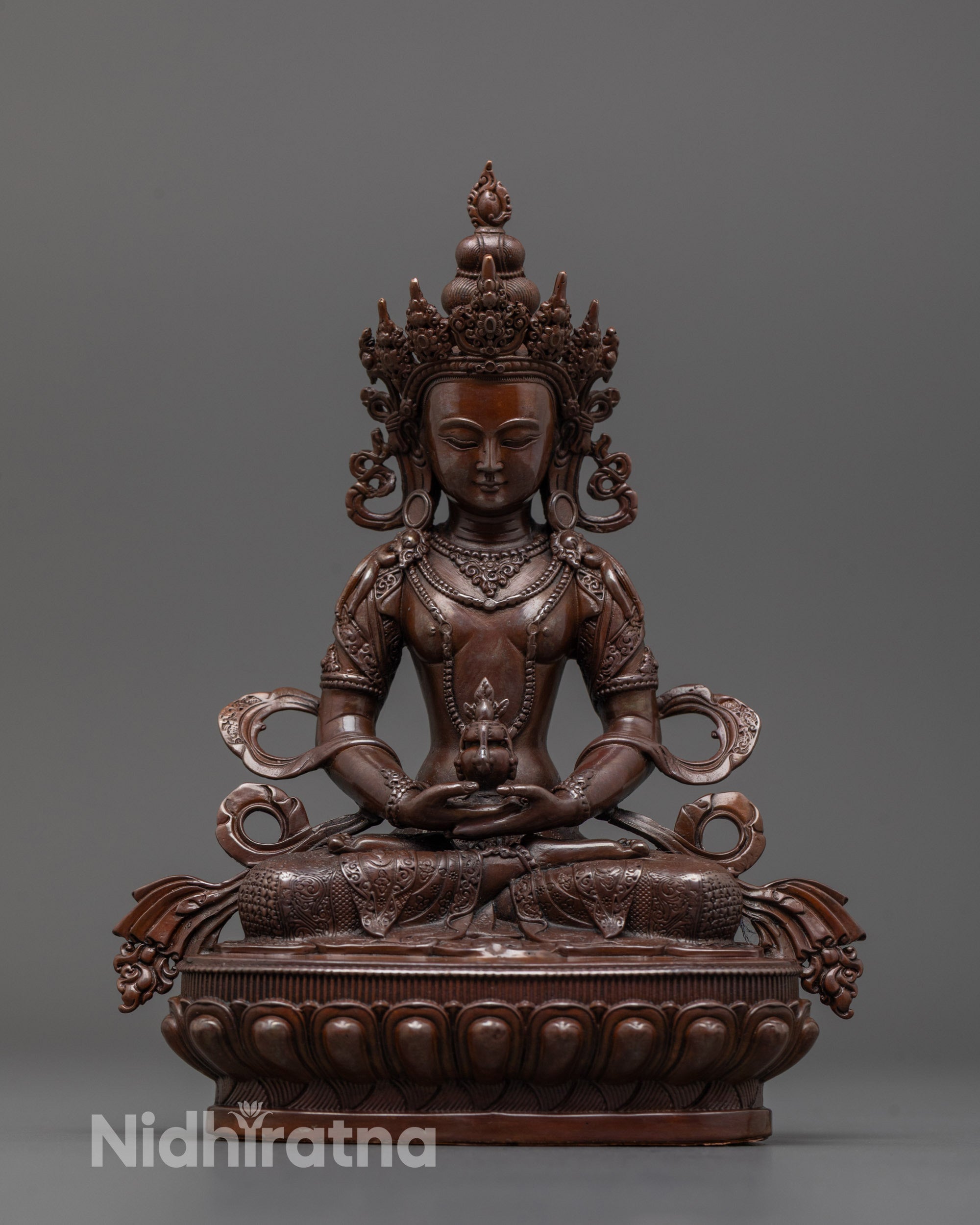 Front view of machine-made Amitayus statue showing precise electroplated oxidized copper finish