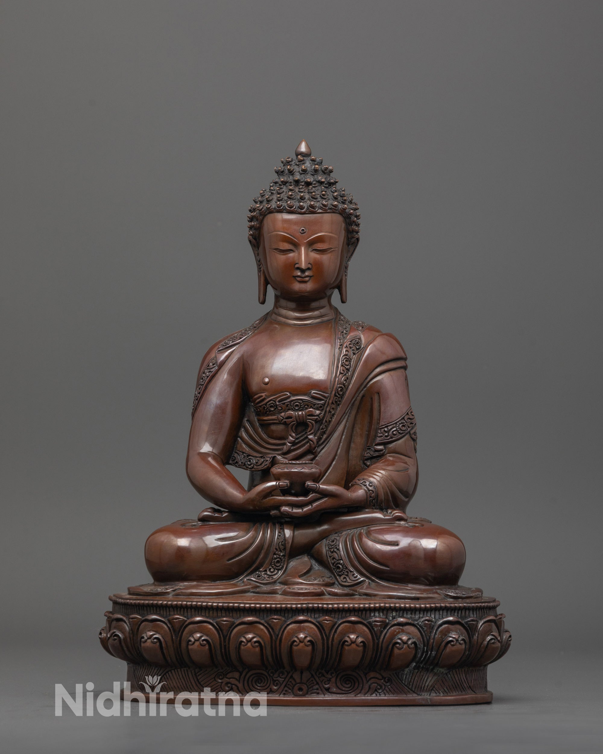 Front view of oxidized Amitabha Buddha statue seated in dhyana mudra with fine carved details