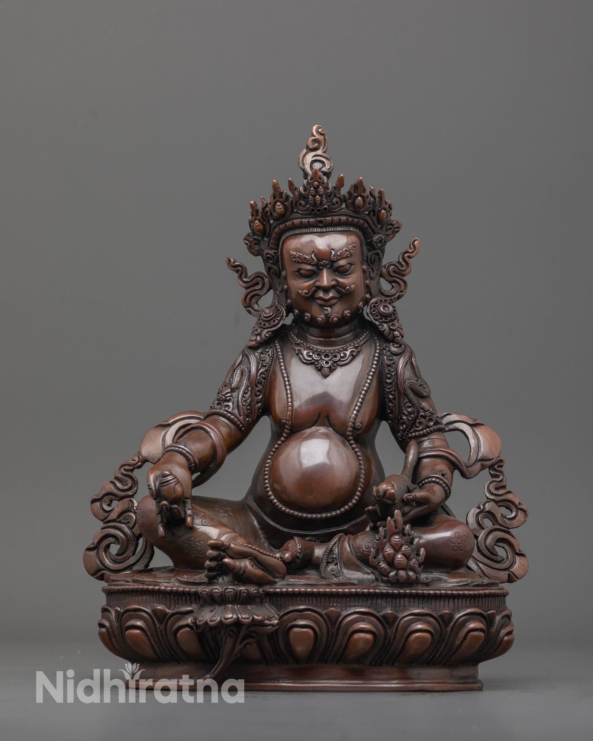 Front view of oxidized Dzambhala statue with jeweled crown and lotus seat detailed carving