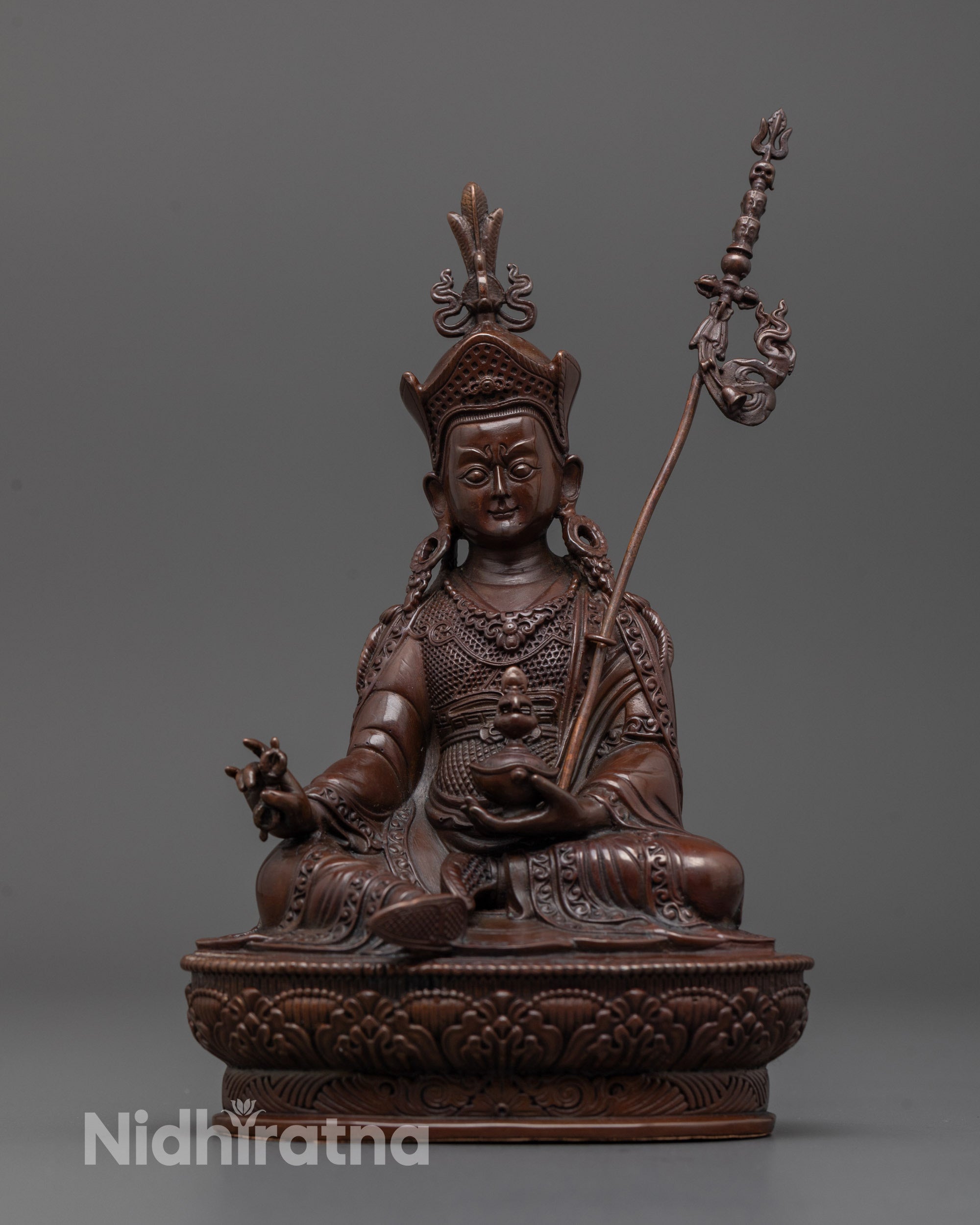 Front view of oxidized Guru Rinpoche statue with electroplated copper and lotus base