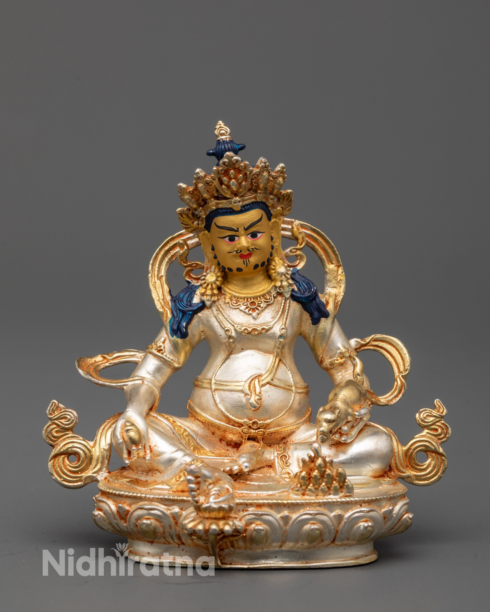 Front view of precision-made Dzambhala idol with gold-coated face and silver-plated body