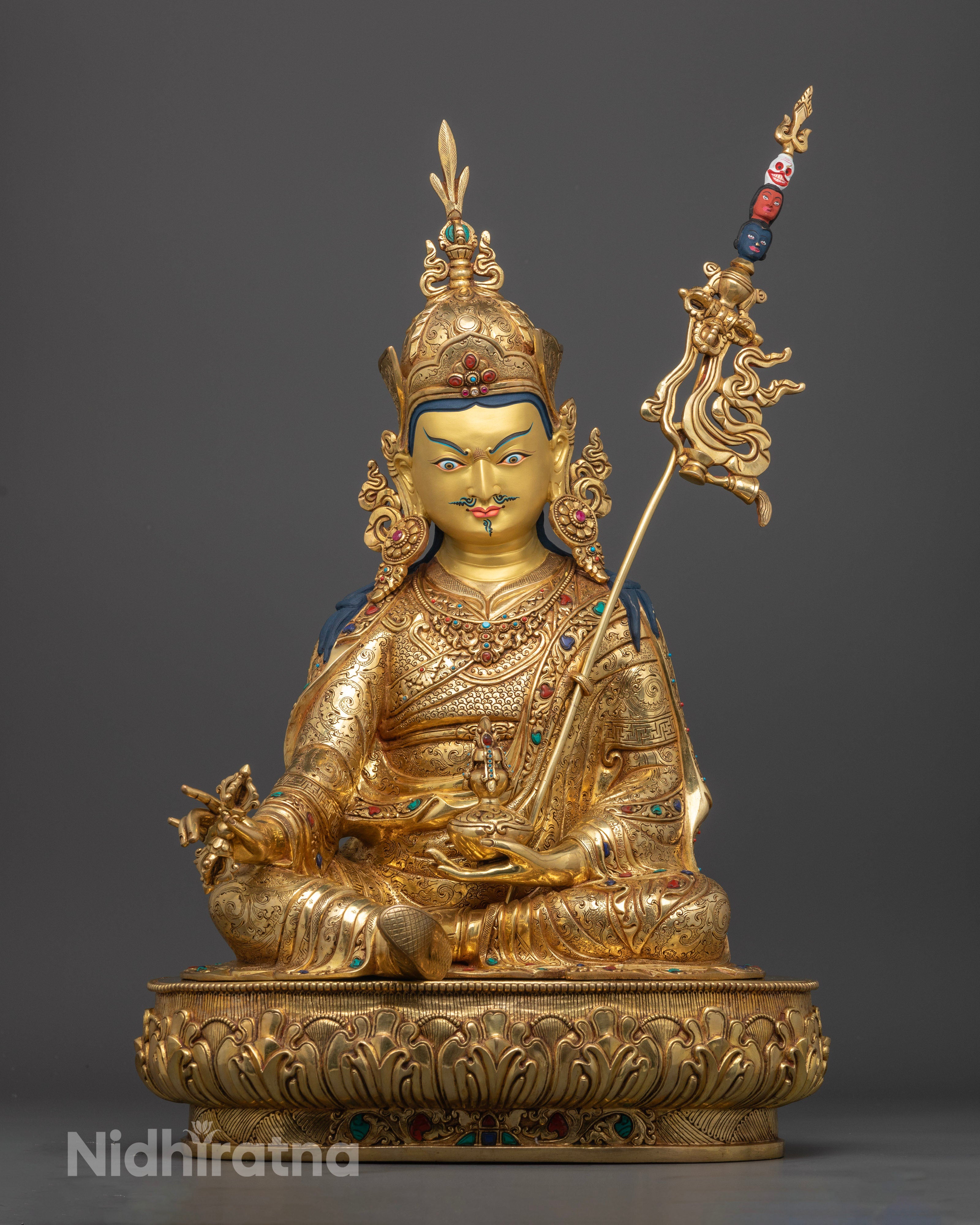 Front view of the Guru Pema Jungne statue on a lotus seat, with a gold-painted face, a handcrafted Nepalese copper Buddhist sculpture