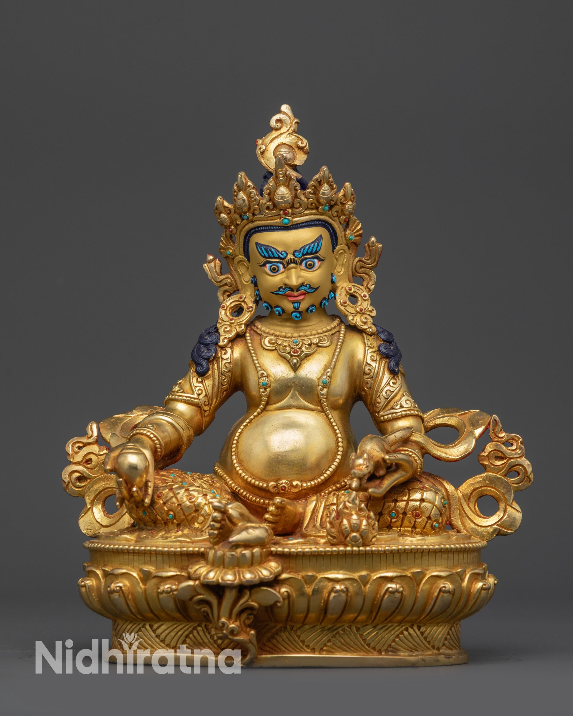 Front view of the Yellow Dzambhala wealth deity statue with mongoose and jewels.