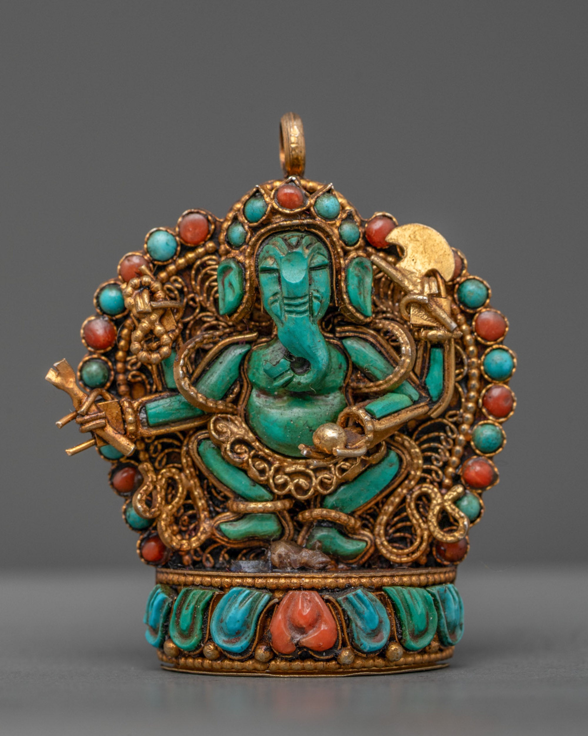 Front view of turquoise Ganesha locket with gold-gilded filigree and semi-precious stones
