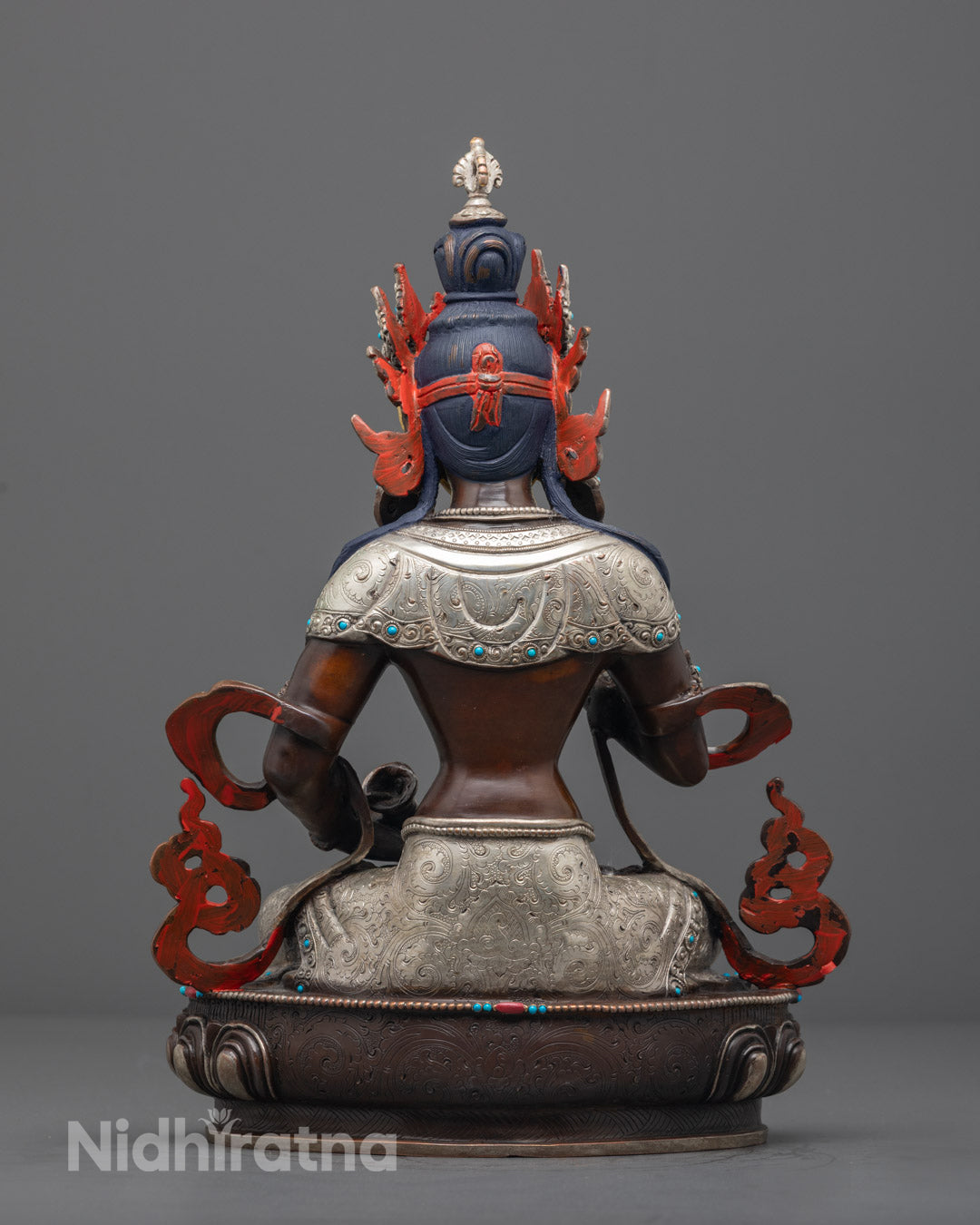Vajrasattva statue seated on a lotus throne, showcasing traditional Tibetan artistry and sacred symbolism.