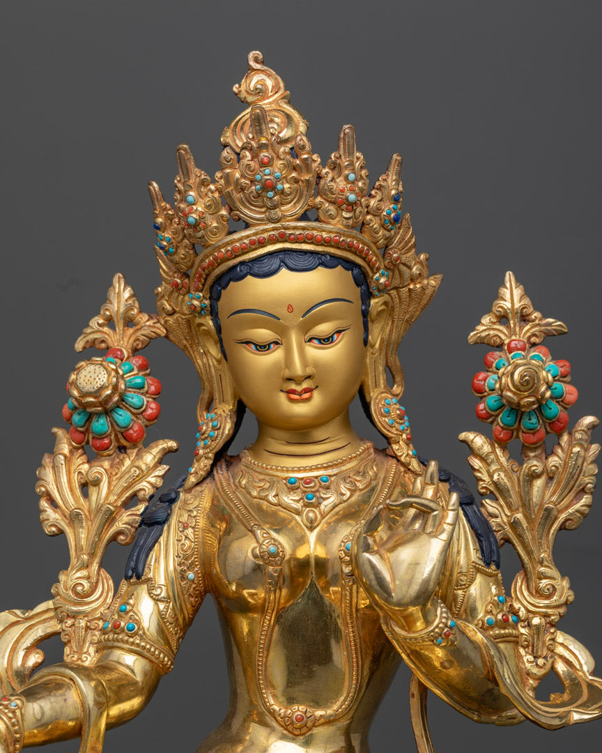 It shows Full Portrait of Green Tara statue with face gold painted and 5 jeweled crown and pema lotus decorated with semi-precious stones