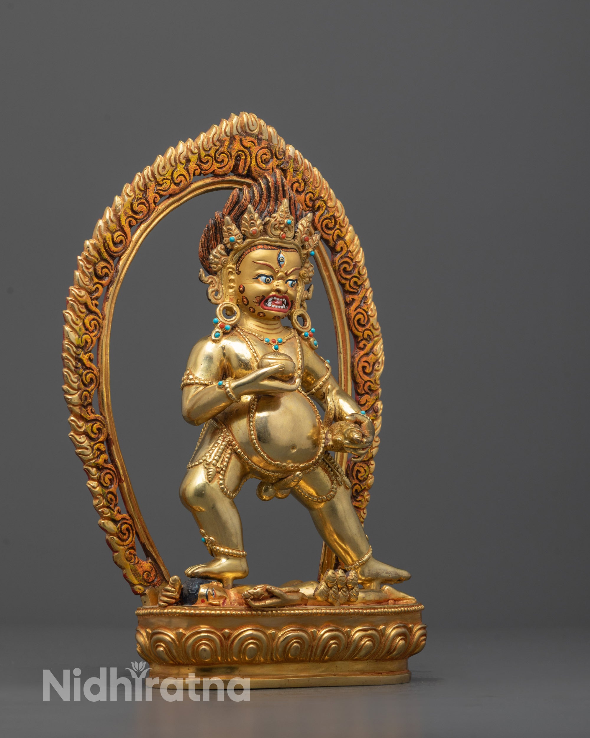 Full View of Black Dzambhala Statue with Human Deity Underfoot