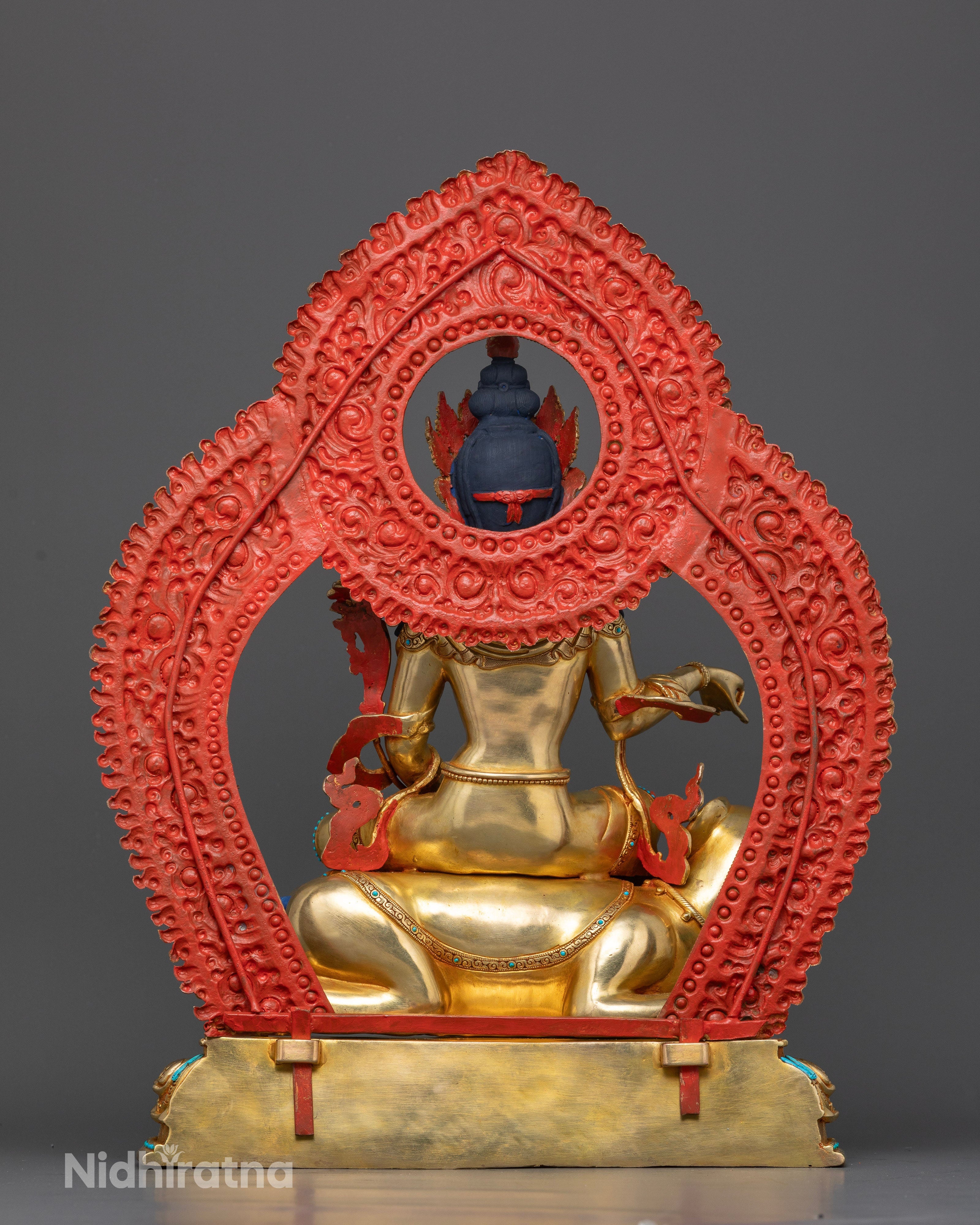 Detailed back view showing halo with semi-precious stones and intricate carvings
