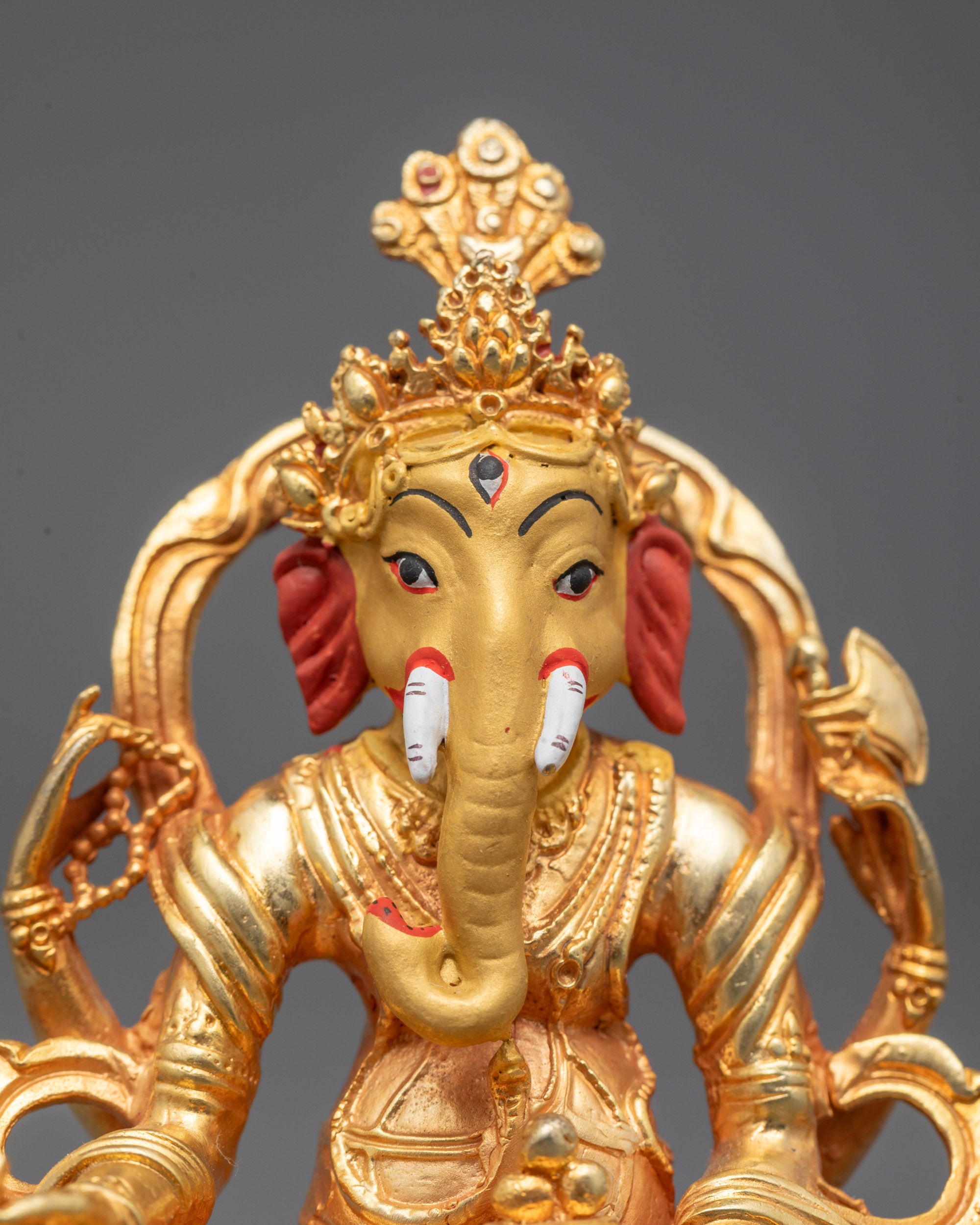 Close-Up of Lord Ganesha’s Serene Face with Detailed Crown